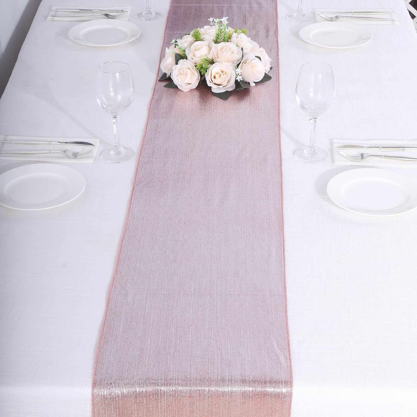 Rose gold shimmer sequin table runner on a white table.