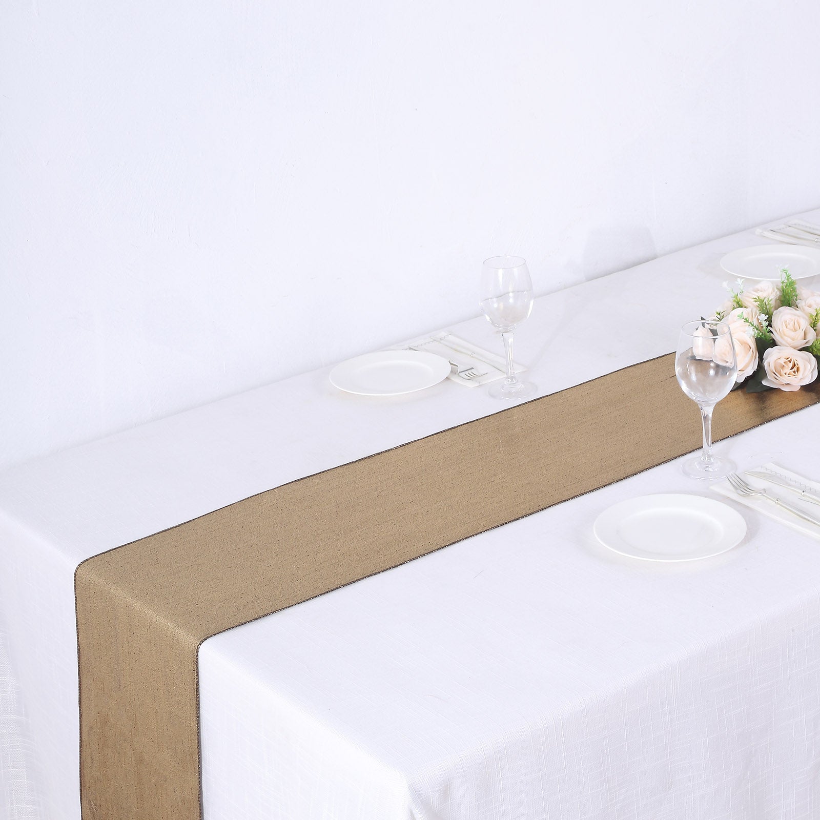 Antique gold shimmer sequin dots table runner on a white table setting.