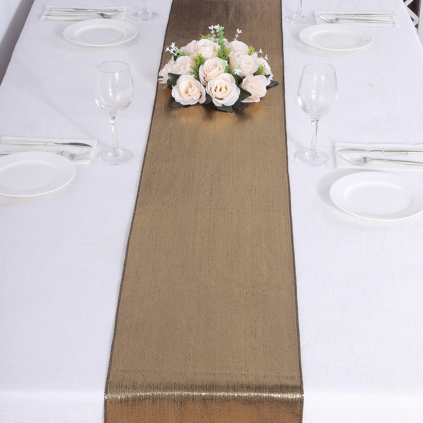 Antique gold shimmer sequin table runner on a white table setting.