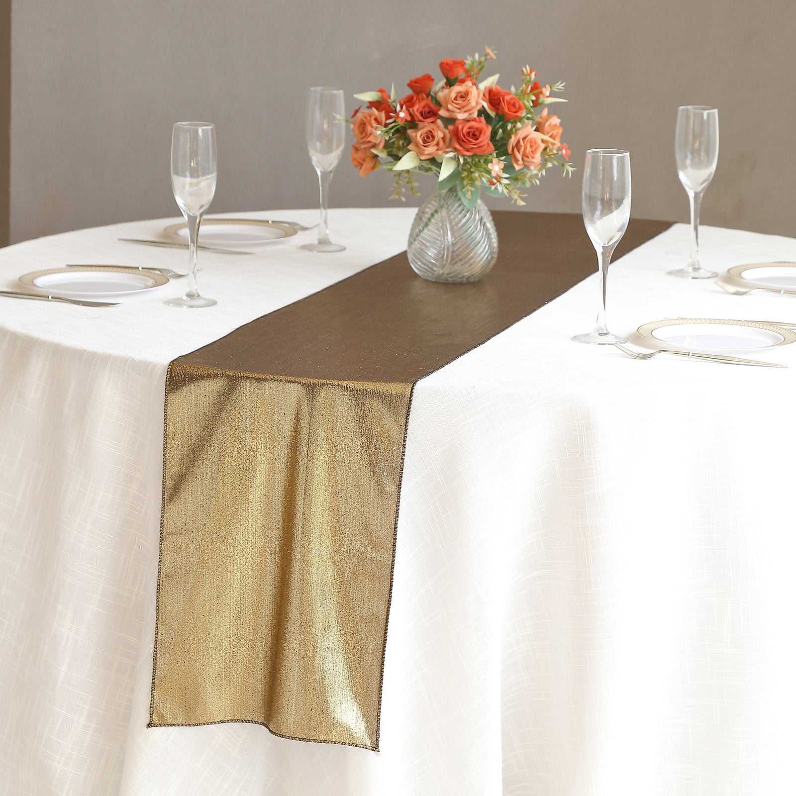 Antique gold shimmer sequin dots table runner on a white tablecloth.