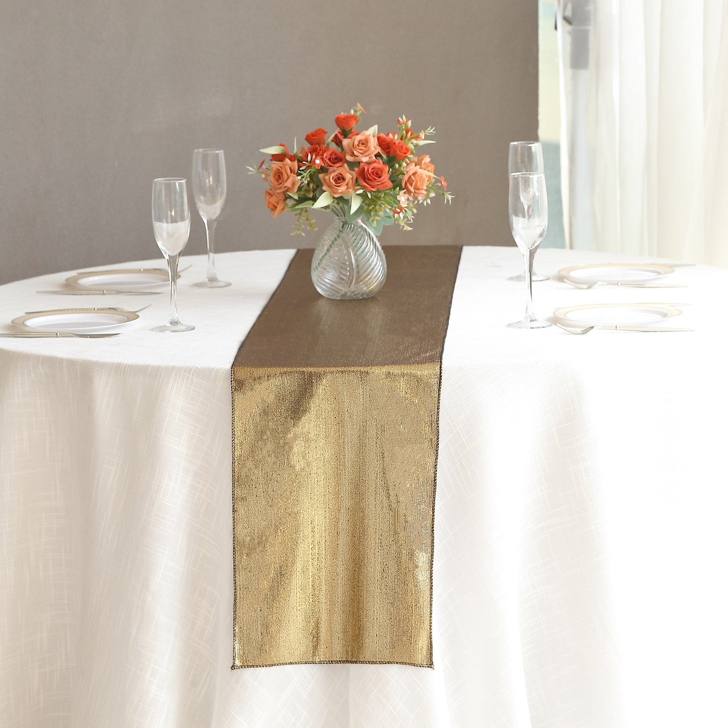 Antique gold shimmer sequin dots table runner on a white table.