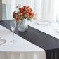 Black shimmer sequin dots table runner on a white table with floral centerpiece.