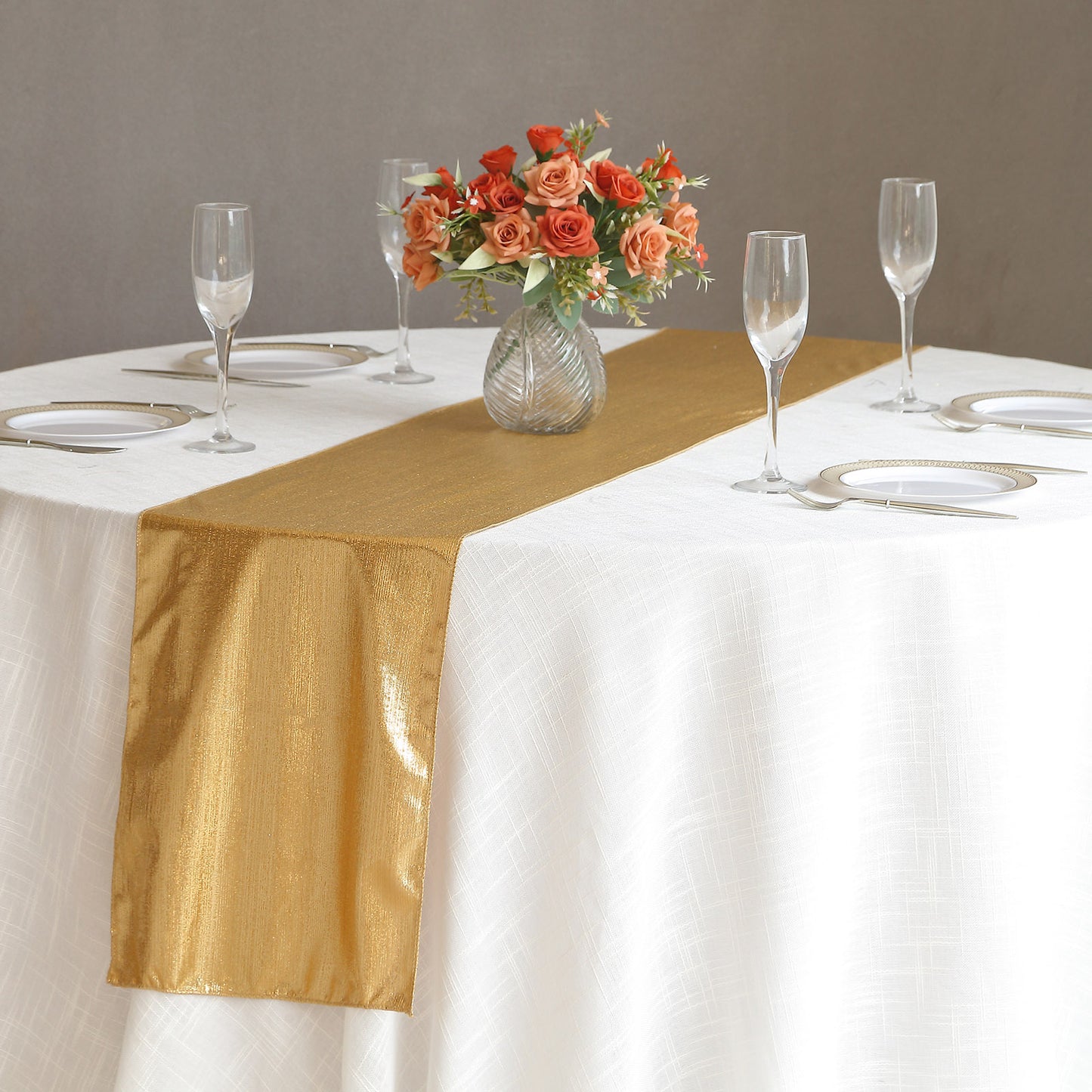 Gold shimmer sequin dots table runner on a white table setting.