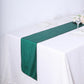 Hunter emerald green table runner on a white table setting.