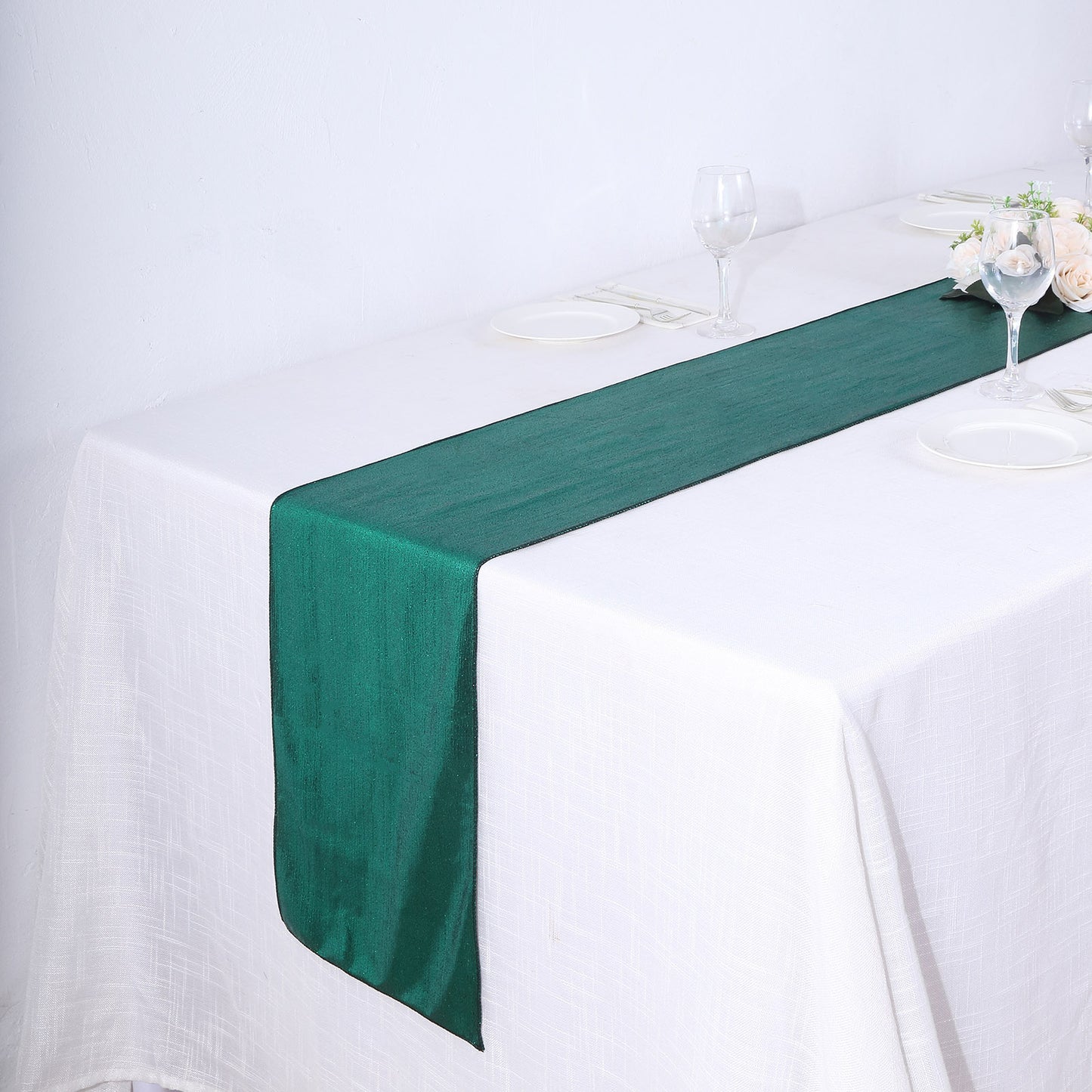 Hunter emerald green table runner on a white table setting.