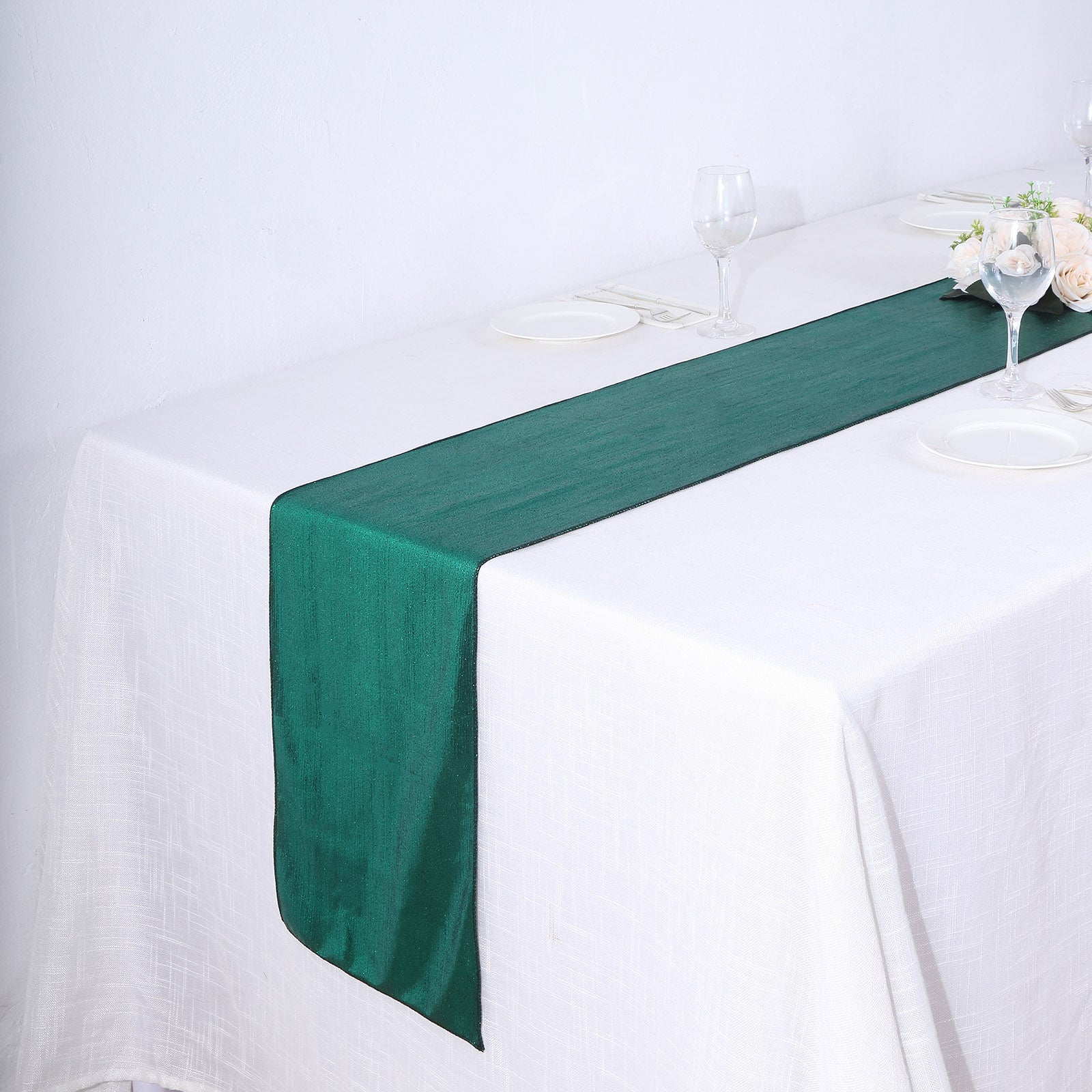Hunter emerald green table runner on a white table setting.