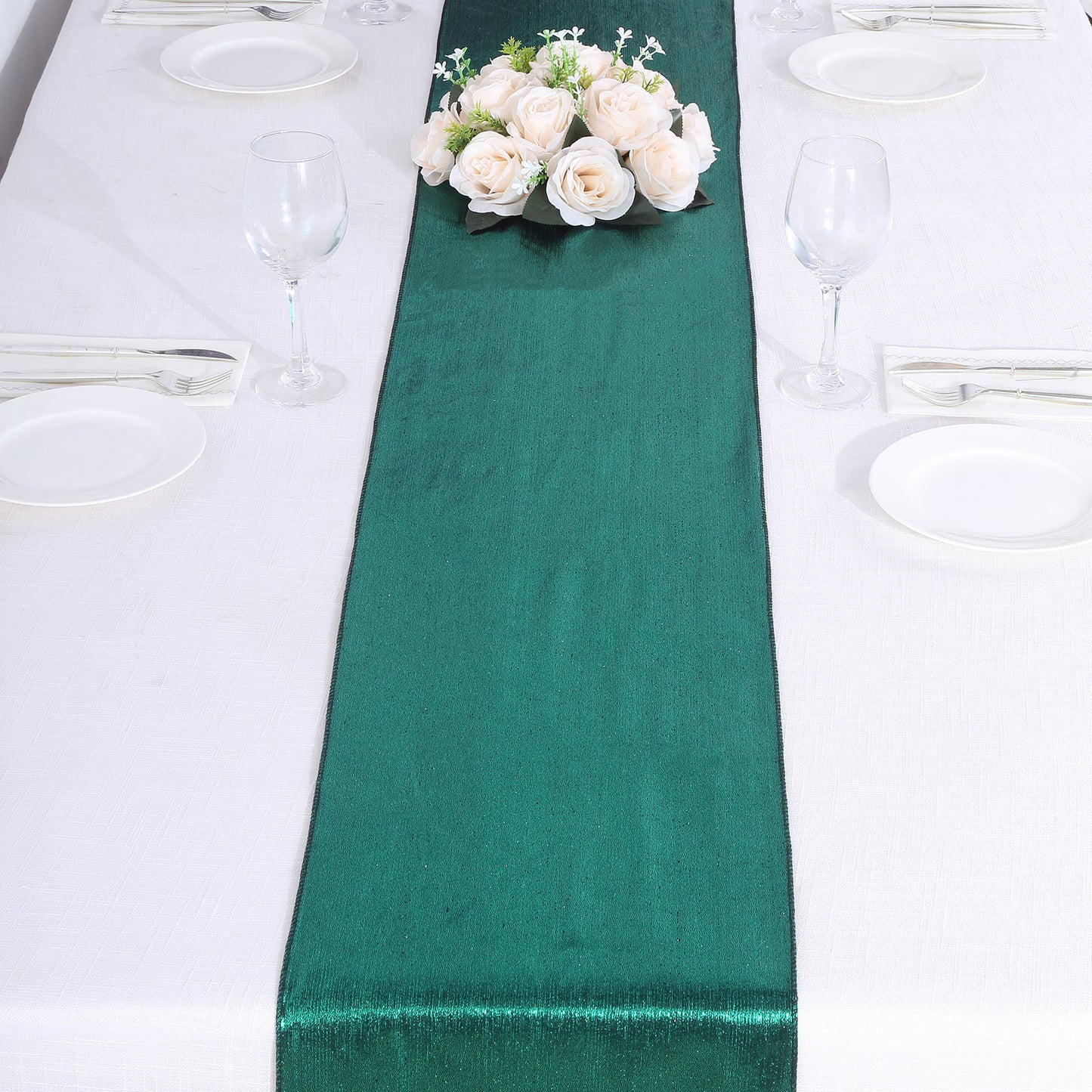 Hunter emerald green table runner with shimmer sequin dots on a white table.