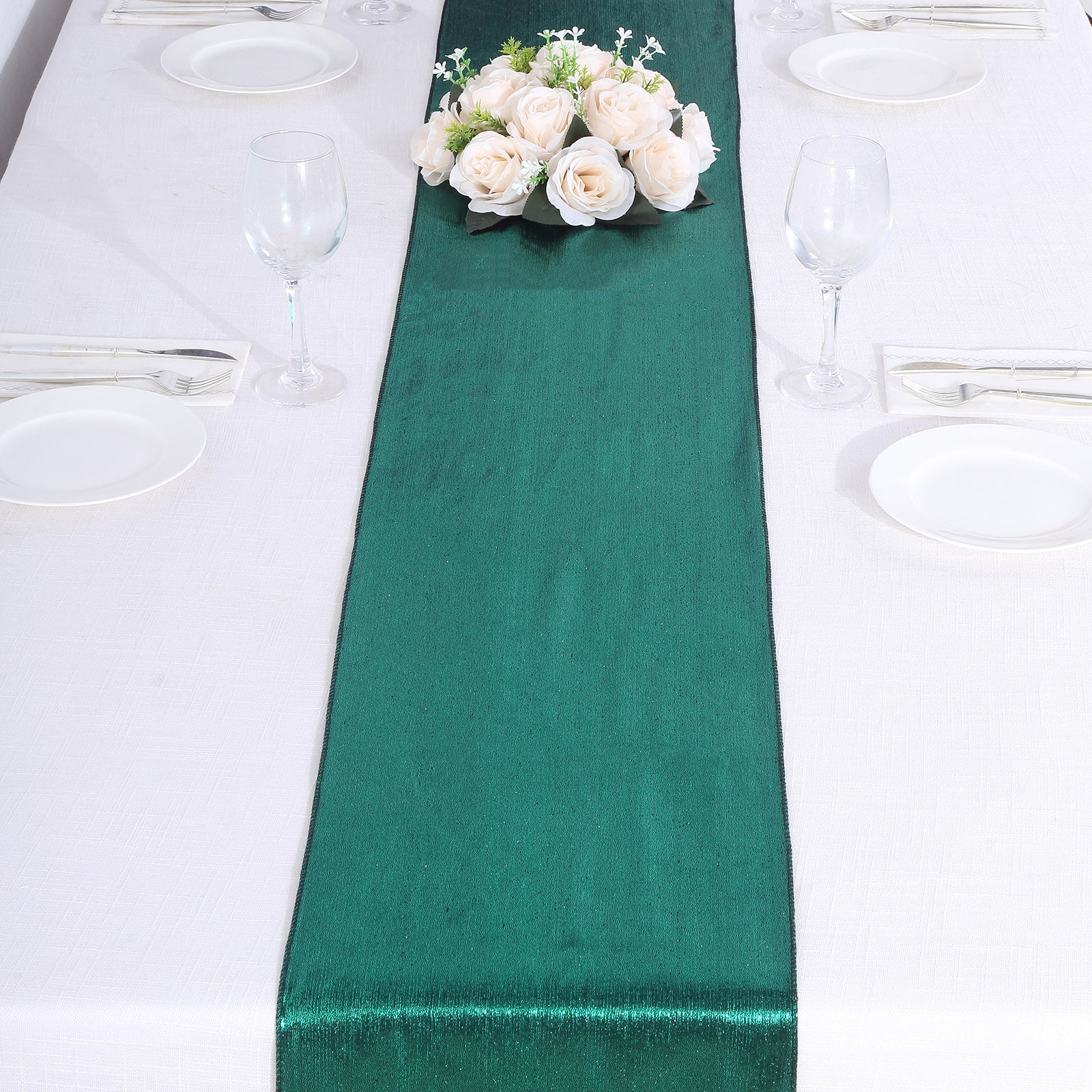 Hunter emerald green table runner with shimmer sequin dots on a white table.