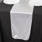 Silver shimmer sequin dots table runner on a black tablecloth.