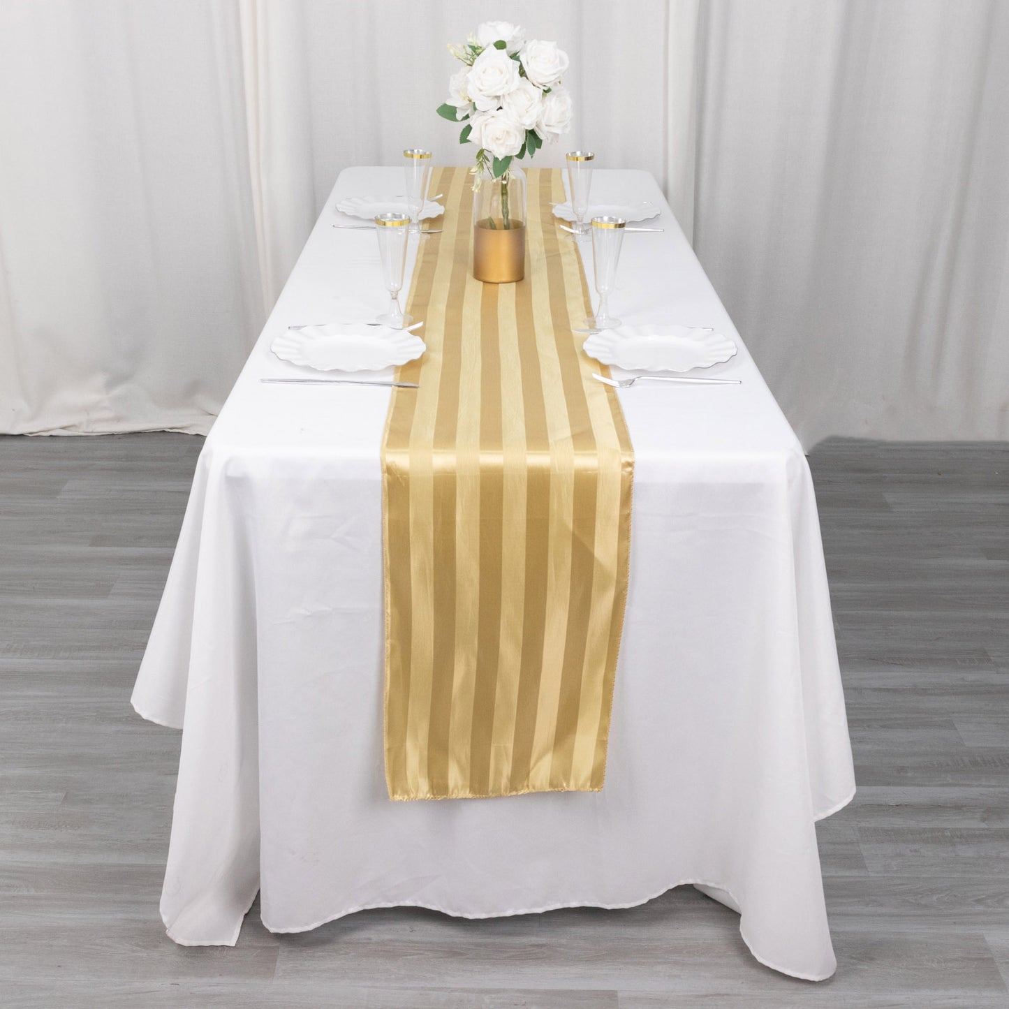 Champagne satin stripe table runner on a white table setting.