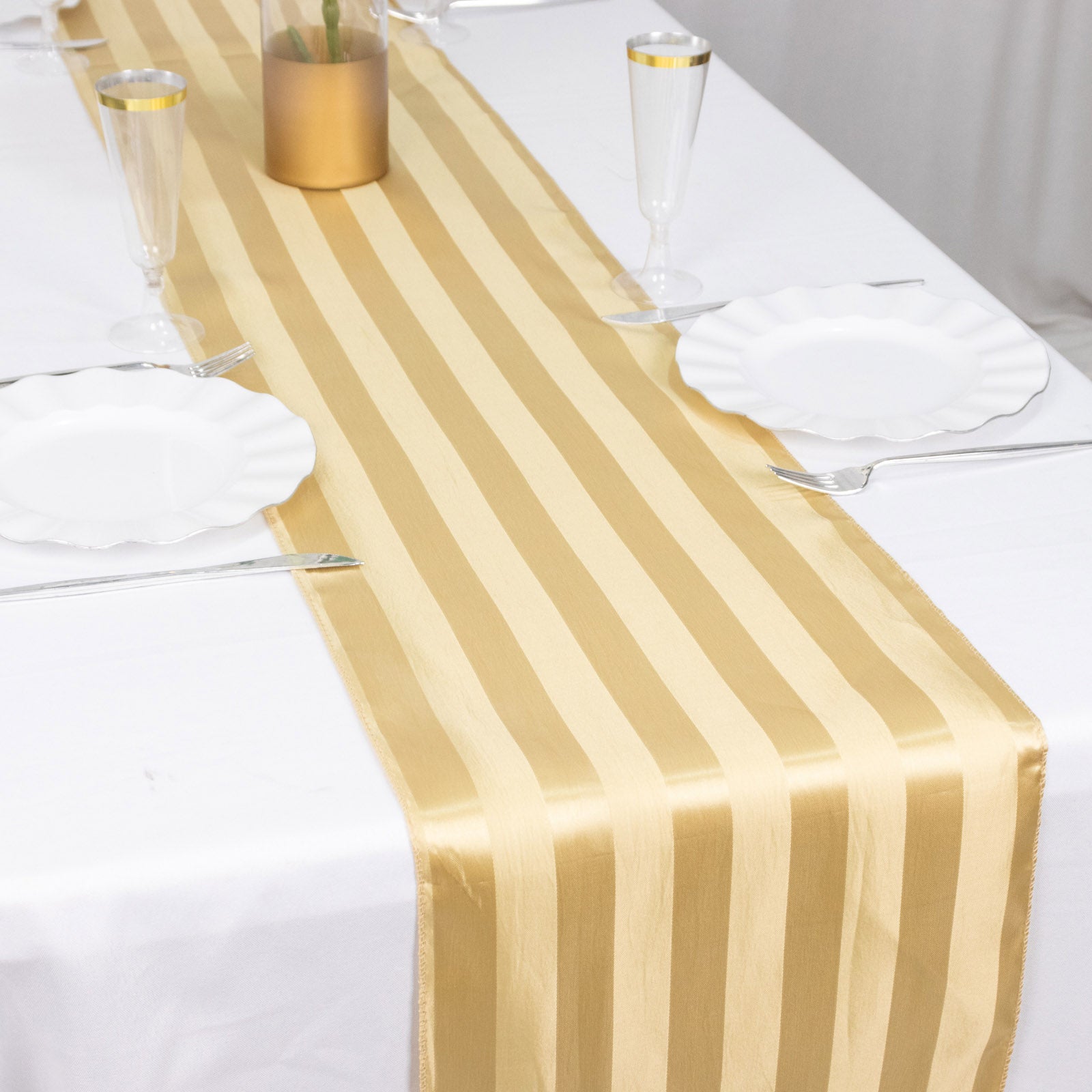 Champagne satin stripe table runner on a white table setting.