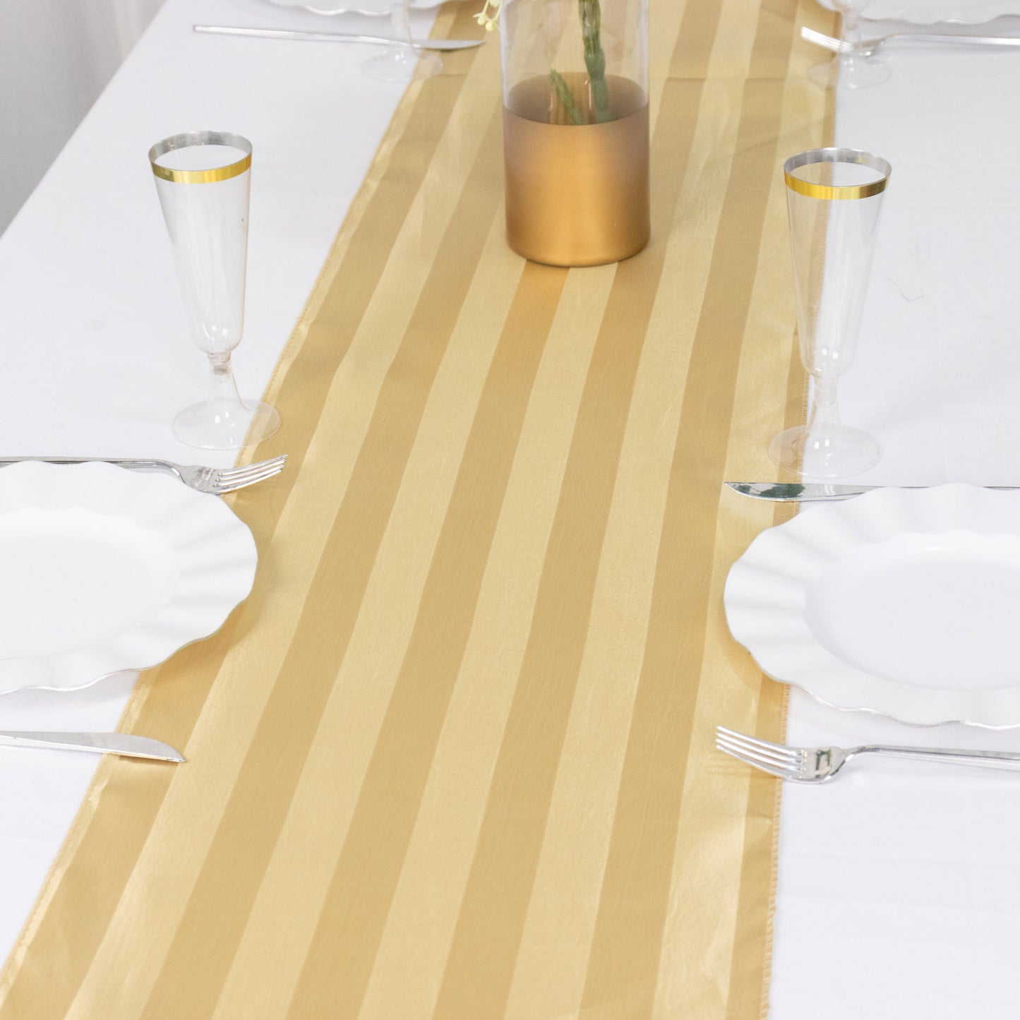 Champagne satin stripe table runner on a dining table setting.