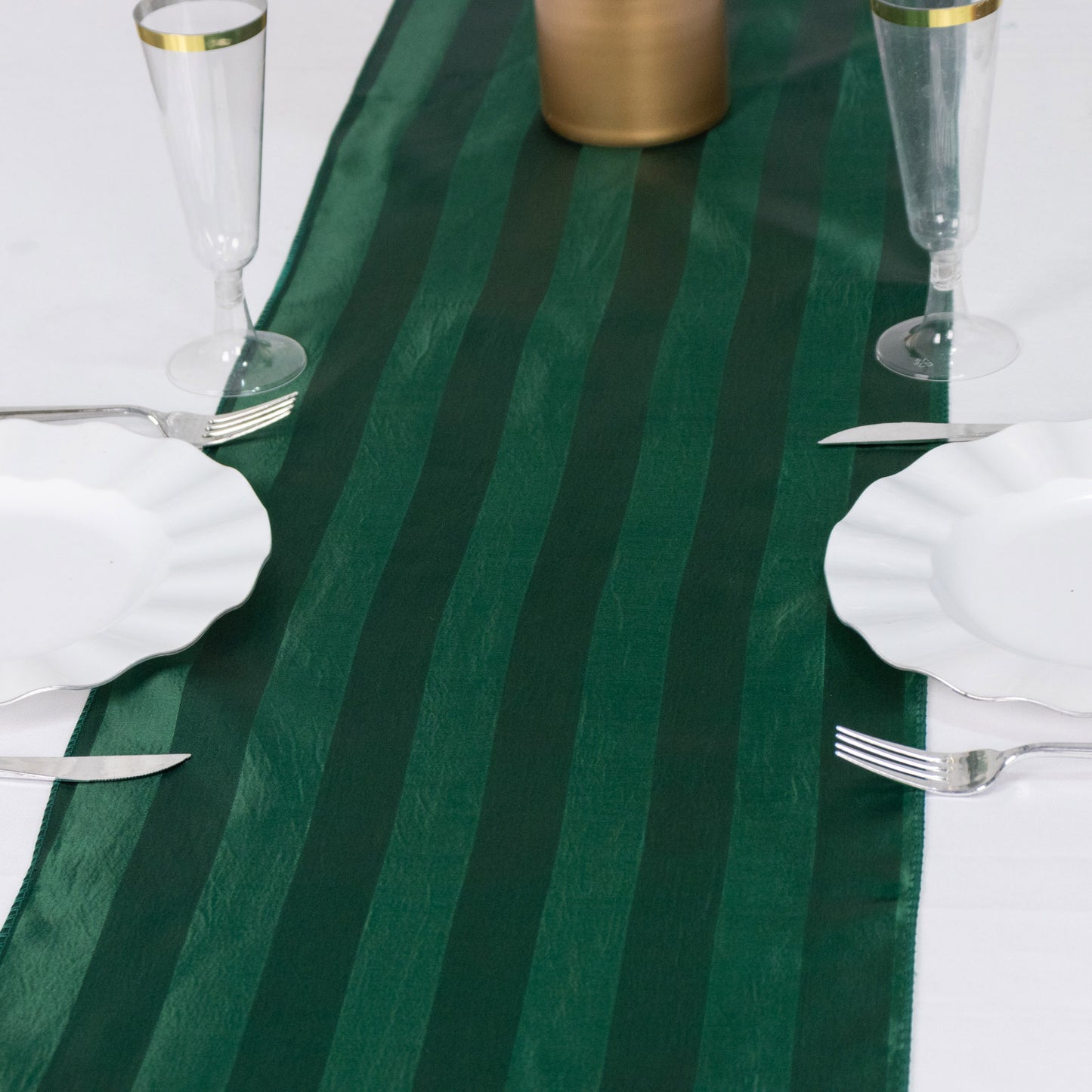 Hunter emerald green satin stripe table runner on a dining table.