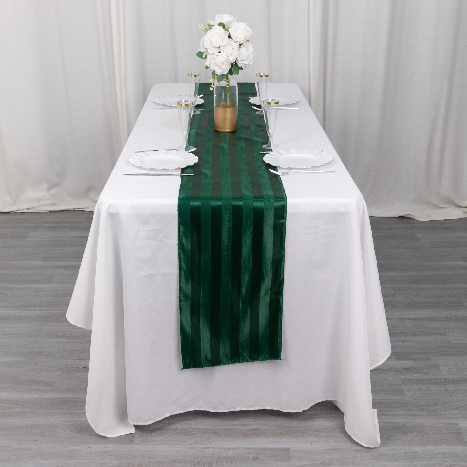 Hunter Emerald Green Satin Stripe Table Runner on a white tablecloth.