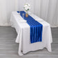 Royal blue satin stripe table runner on a white table.
