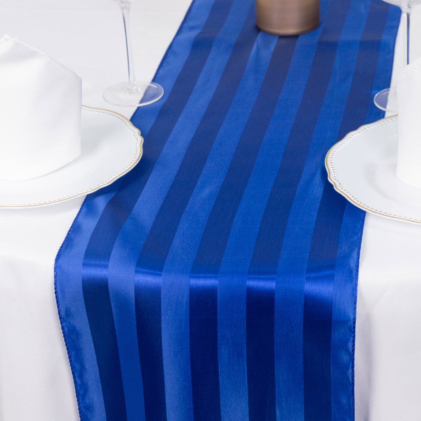Royal blue satin stripe table runner on a dining table.