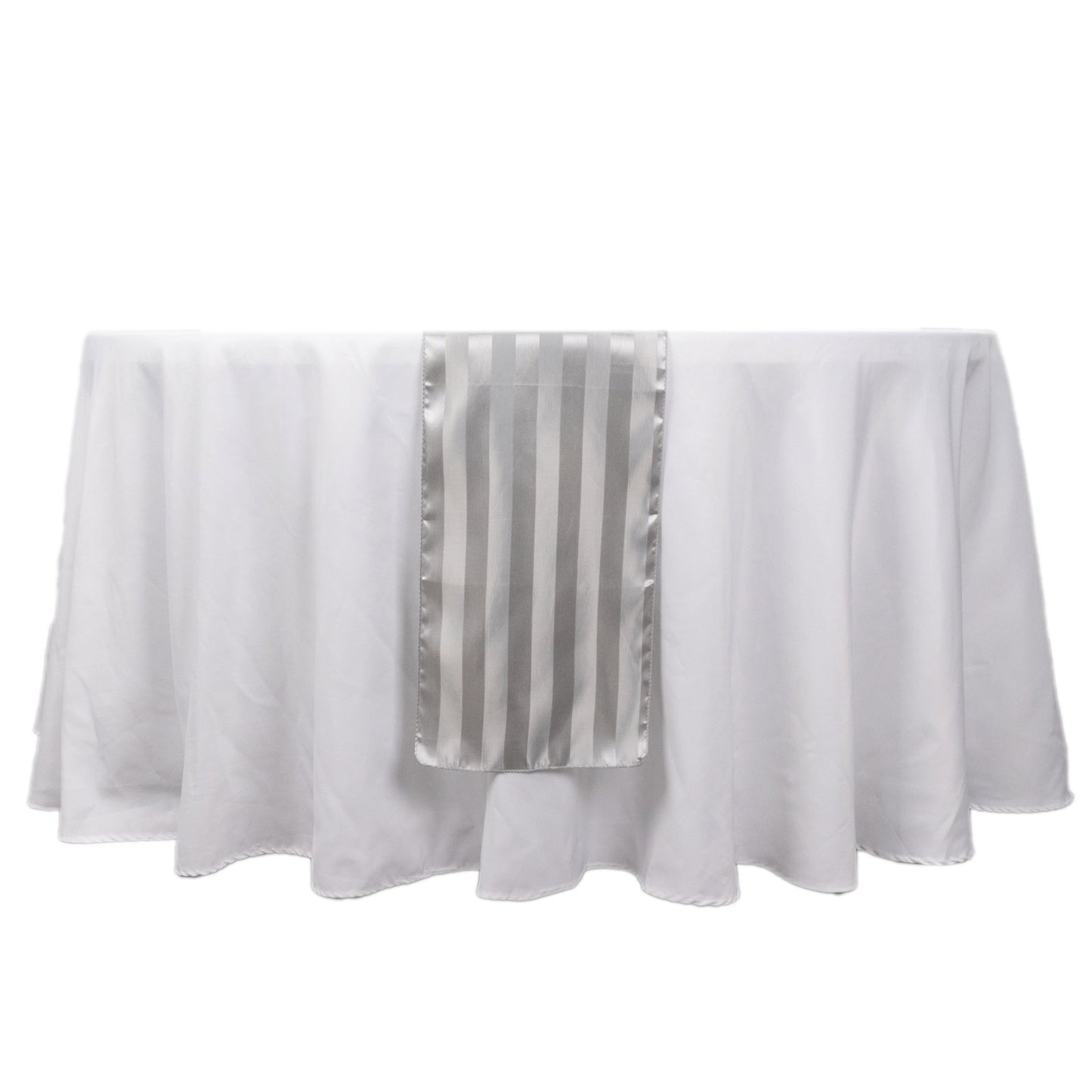 Silver satin stripe table runner on a white tablecloth.