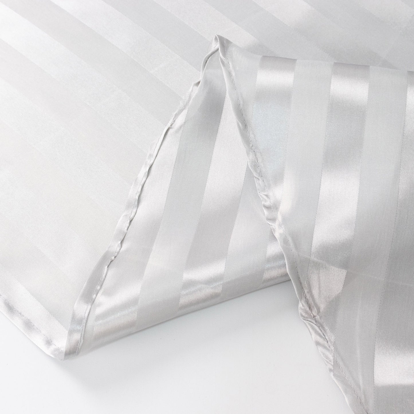 Silver satin stripe table runner, elegant and stylish for any occasion.