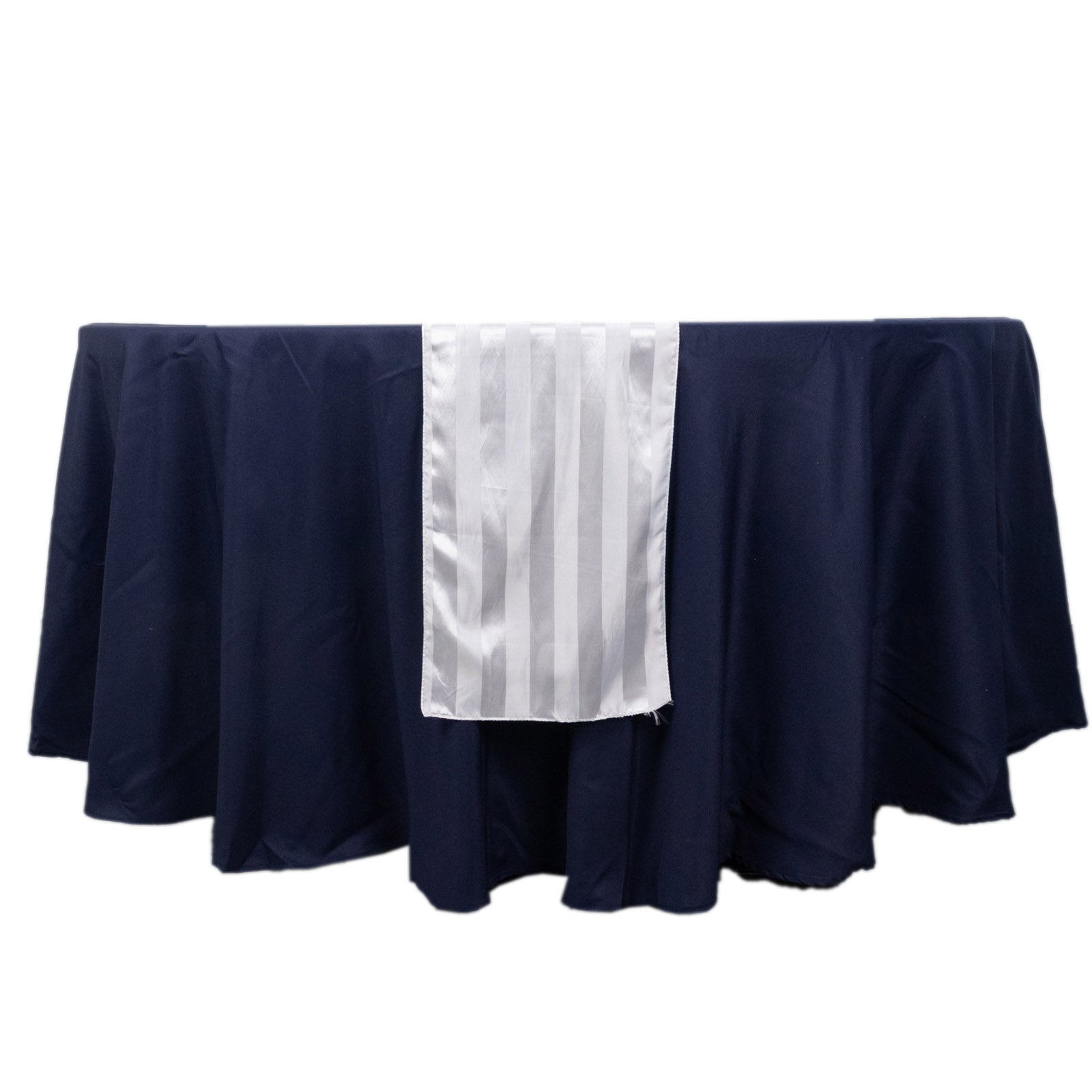 White satin stripe table runner on a navy blue table.