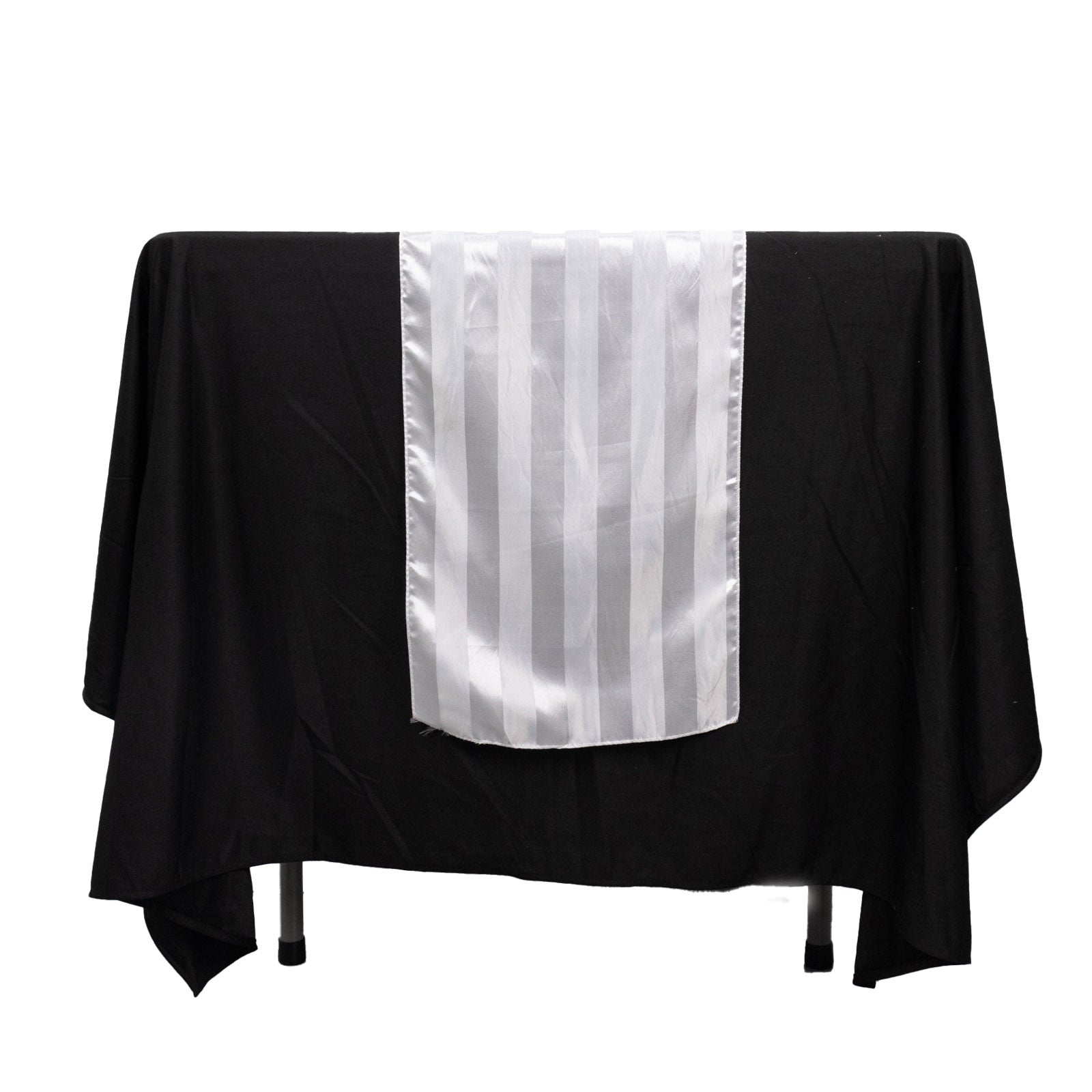 White satin stripe table runner on a black tablecloth.
