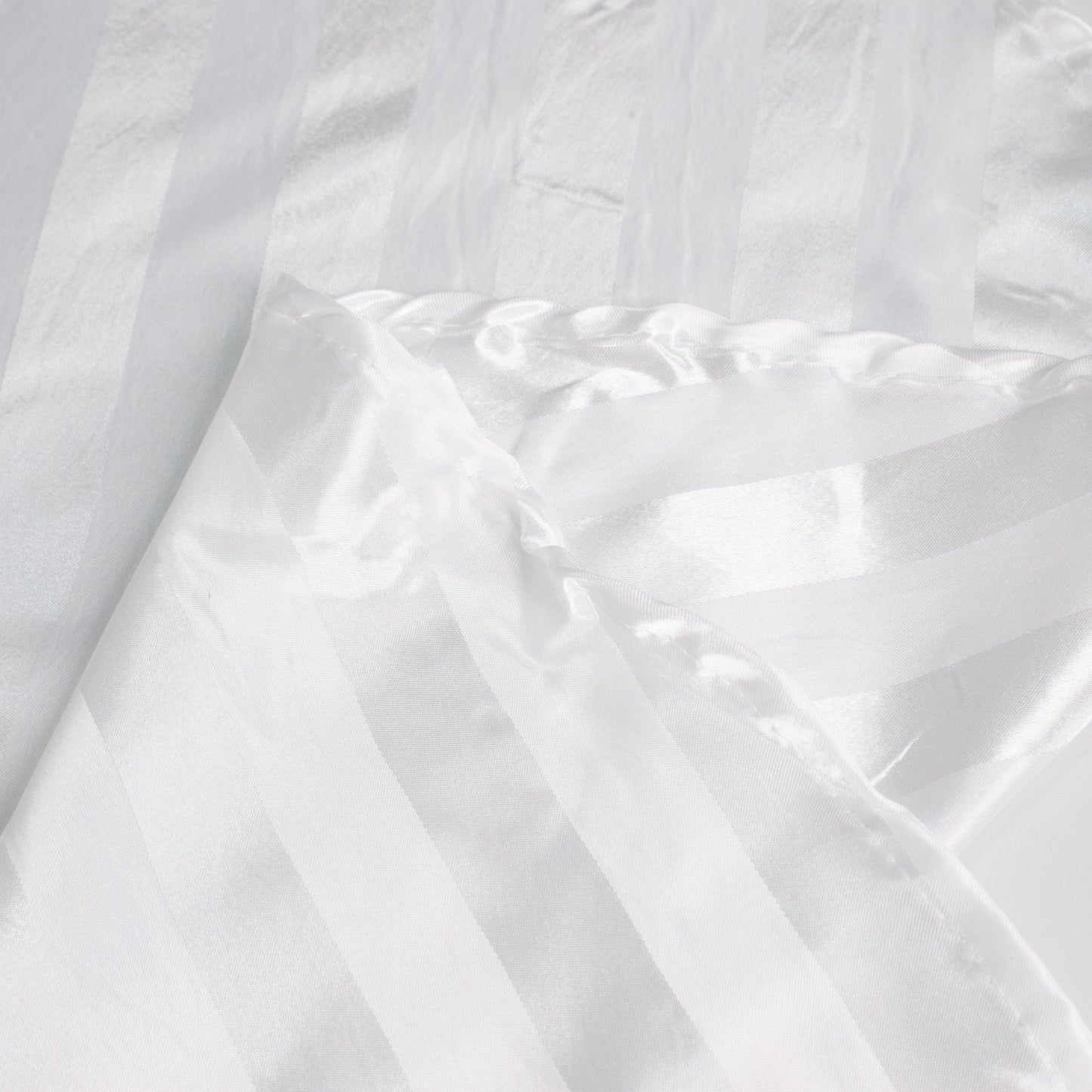 White satin stripe table runner, elegant design for special occasions.
