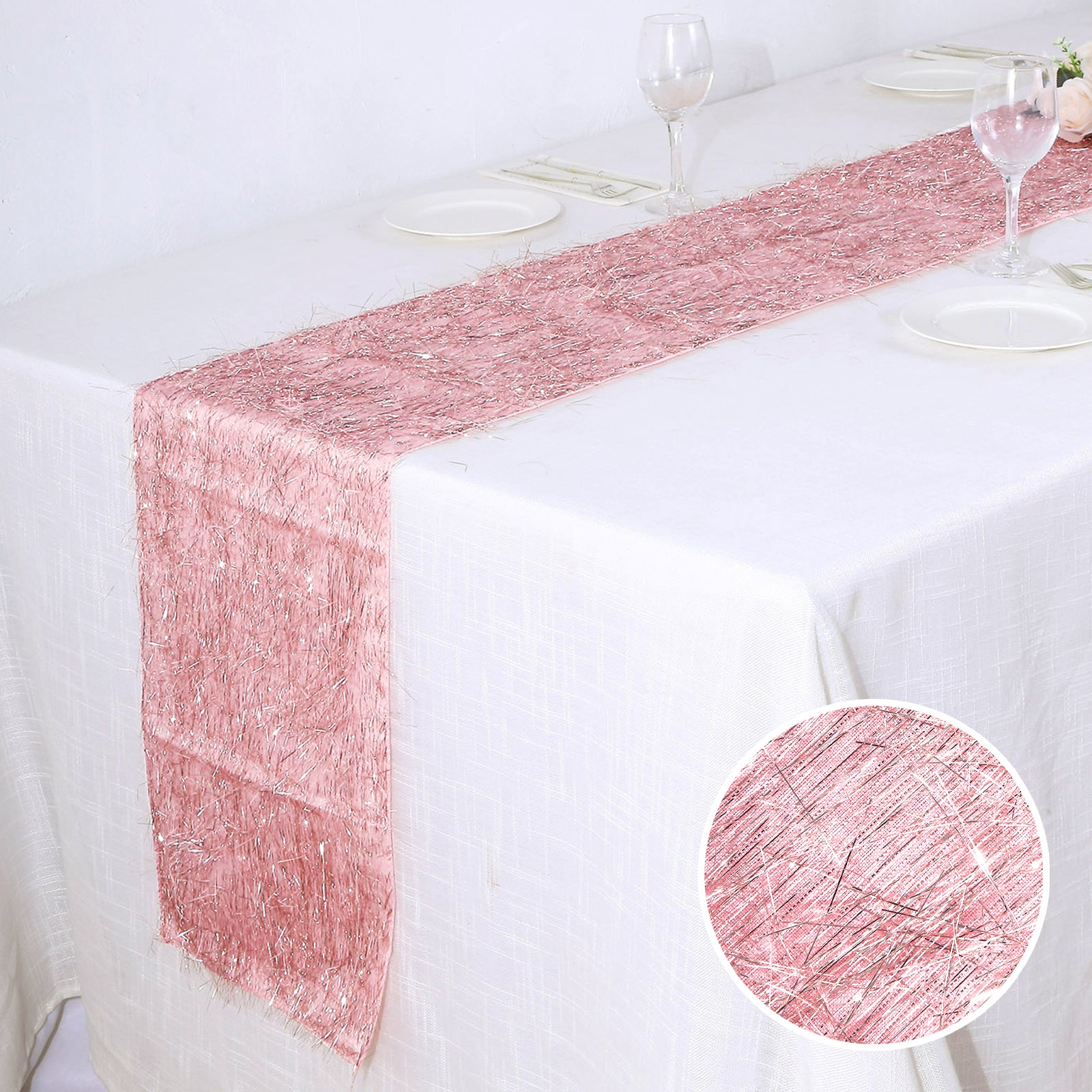 Rose gold metallic fringe tinsel table runner on a white table.