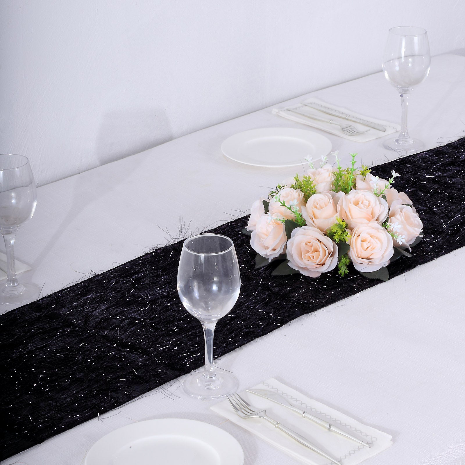 Black metallic fringe table runner with shimmery detail on a dining table.