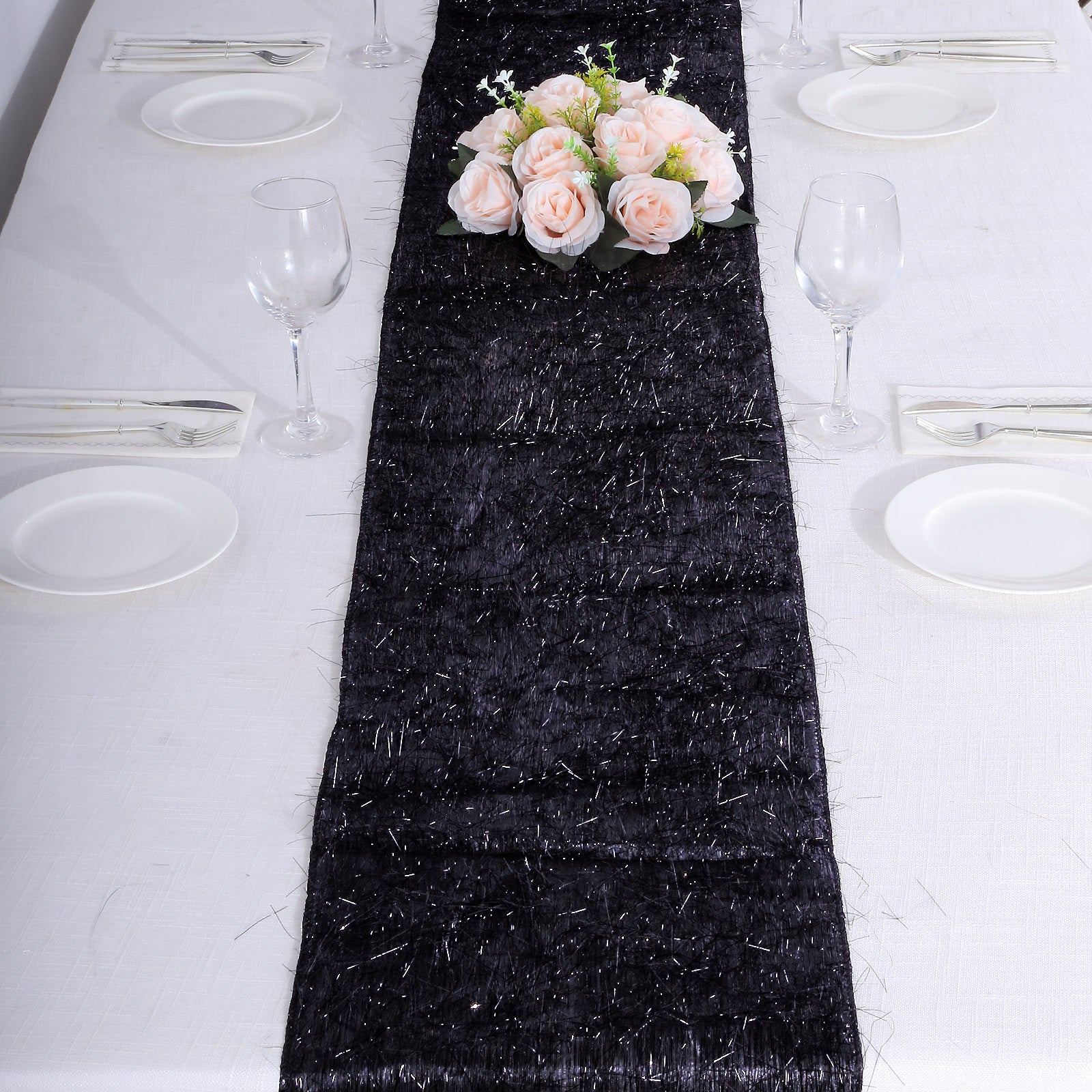 Black metallic fringe shag tinsel table runner on a dining table.