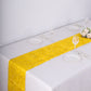 Gold Metallic Fringe Shag Tinsel Table Runner on a white table.