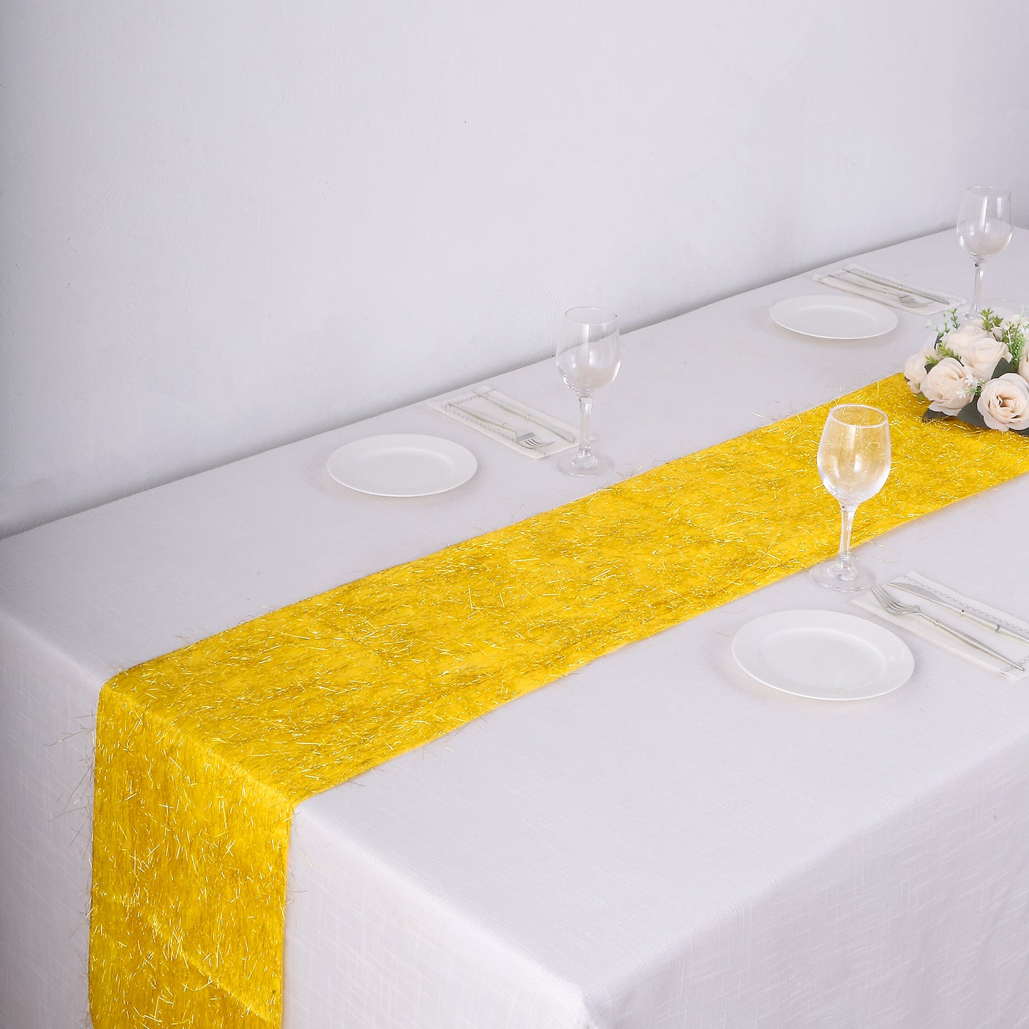 Gold Metallic Fringe Shag Tinsel Table Runner on a white table.