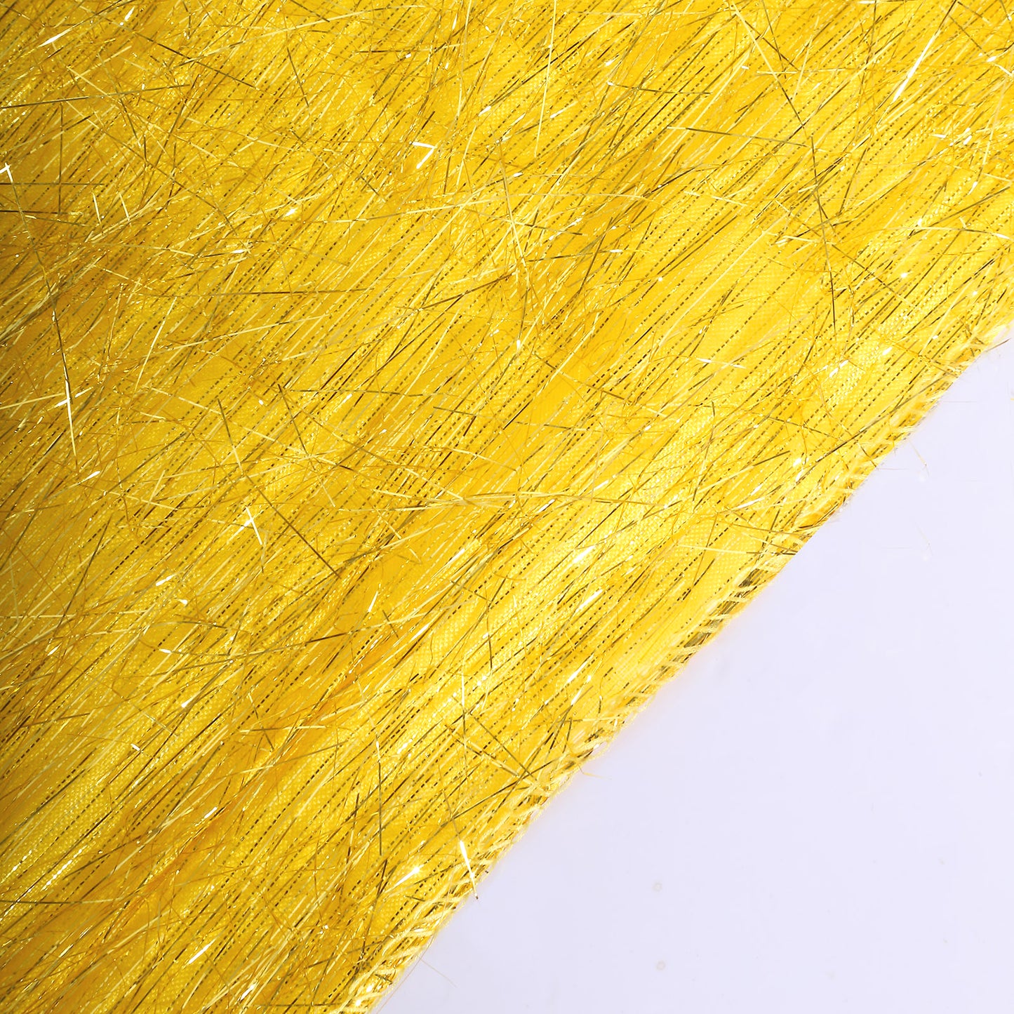Gold metallic fringe shag tinsel table runner on a white surface.