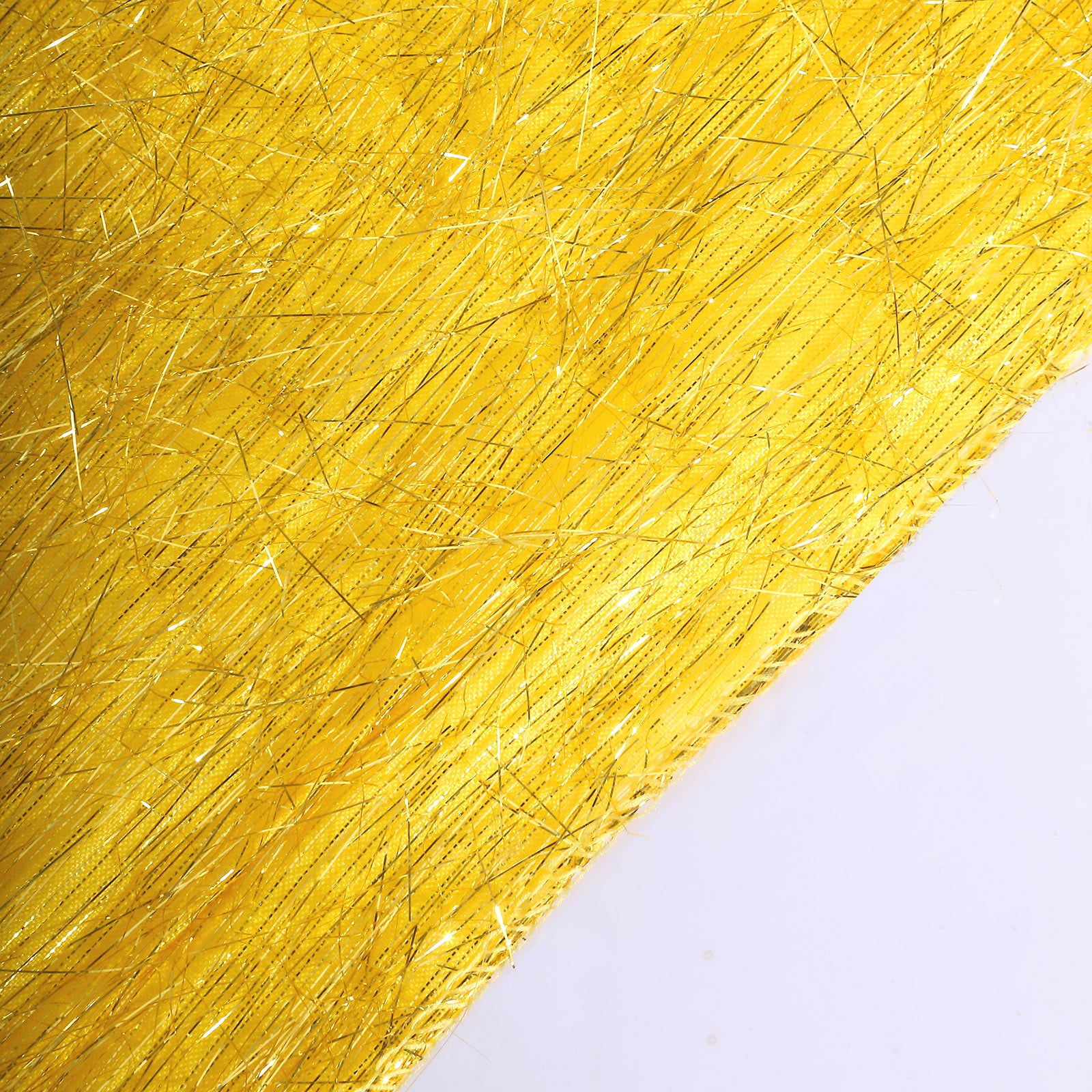 Gold metallic fringe shag tinsel table runner on a white surface.