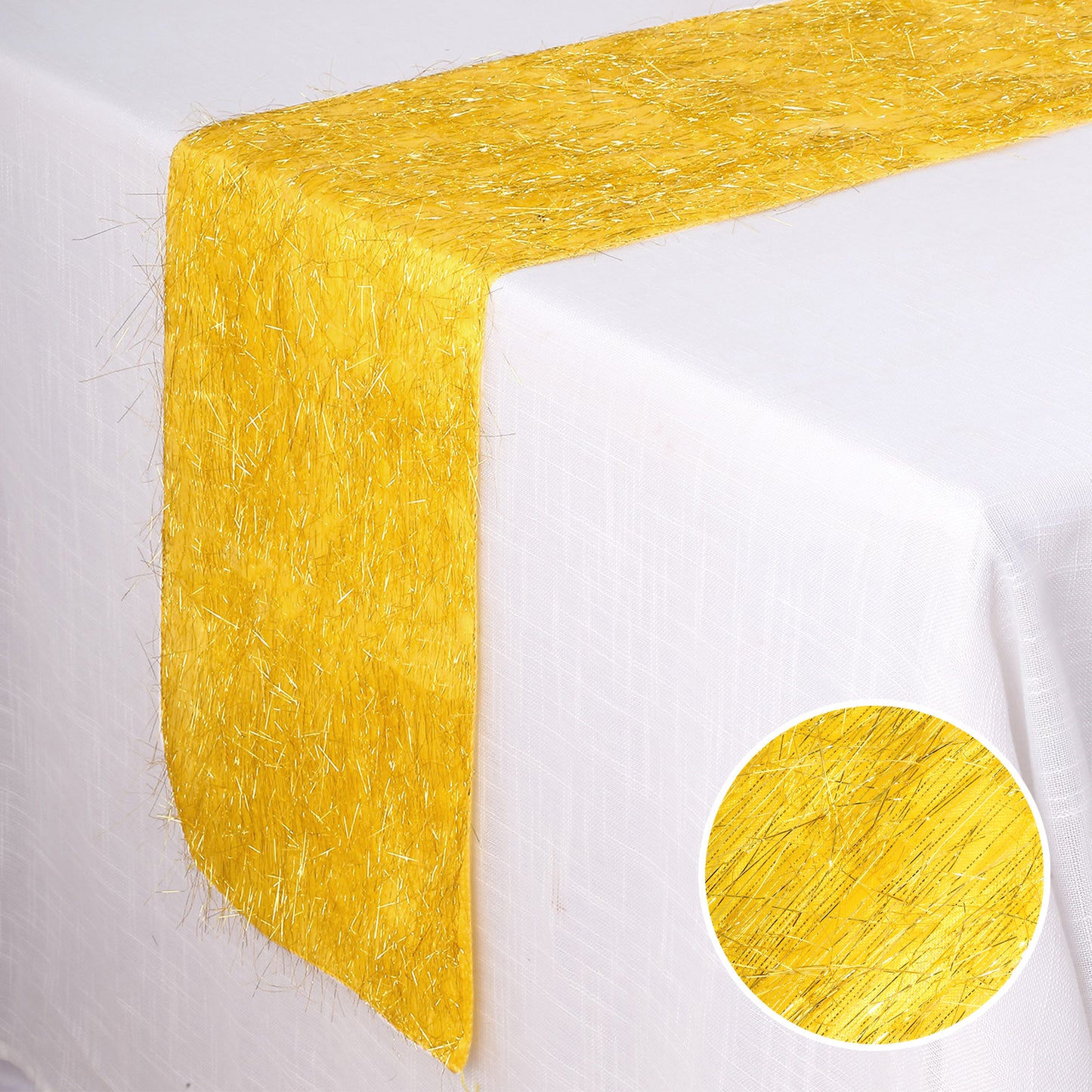 Gold metallic fringe tinsel table runner on a white table.