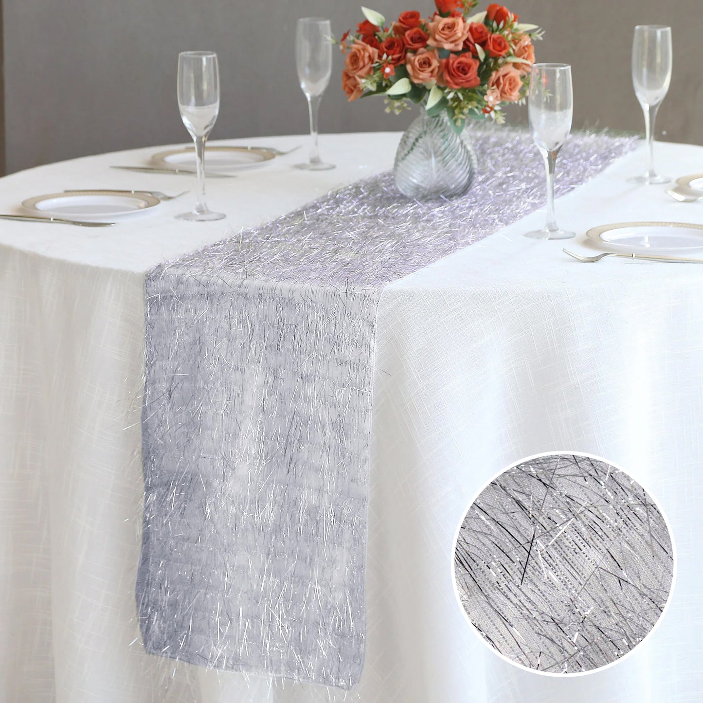 Silver metallic fringe table runner on a white table.