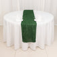 Green shag minky polyester table runner on a round white table.