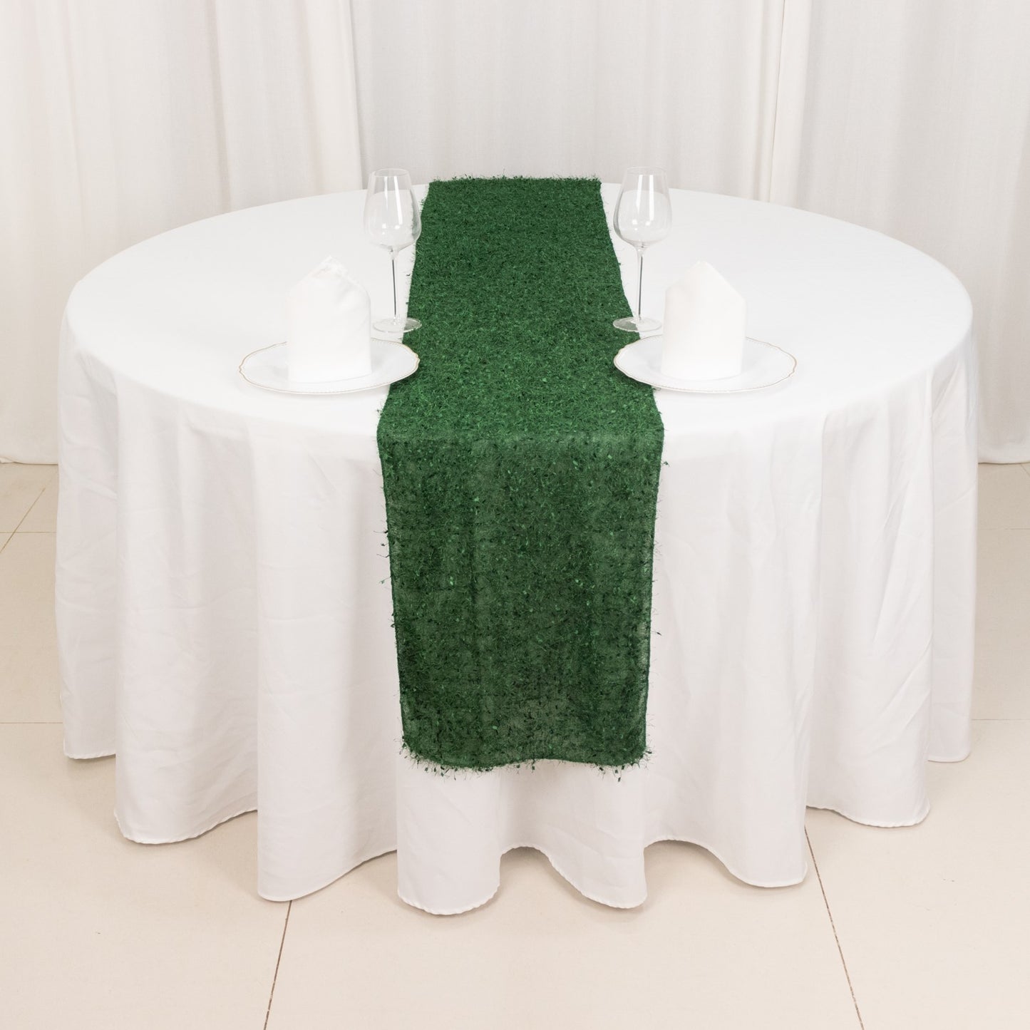 Green shag minky polyester table runner on a round white table.