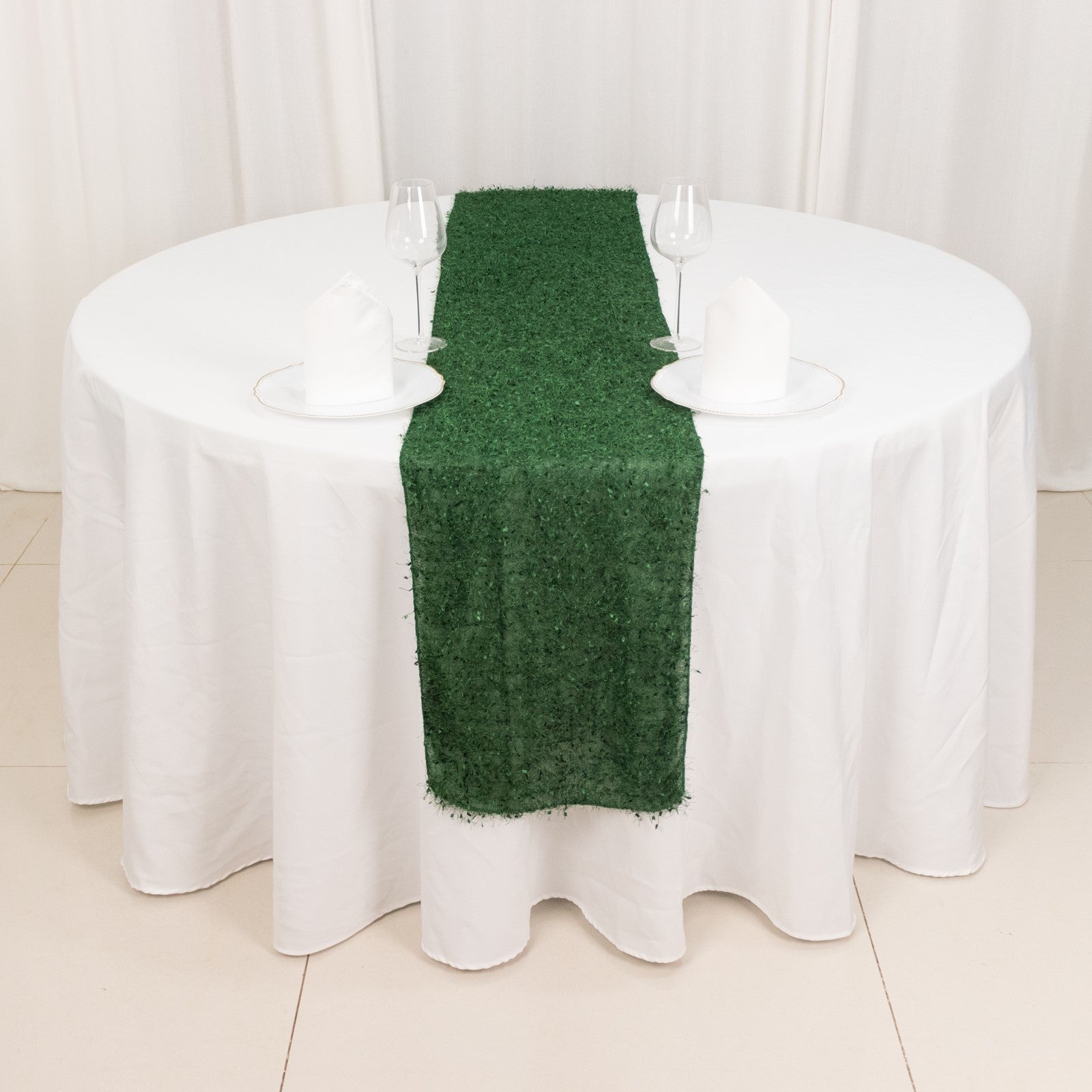 Green shag minky polyester table runner on a round white table.