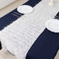 White shag minky polyester table runner on a navy blue table.