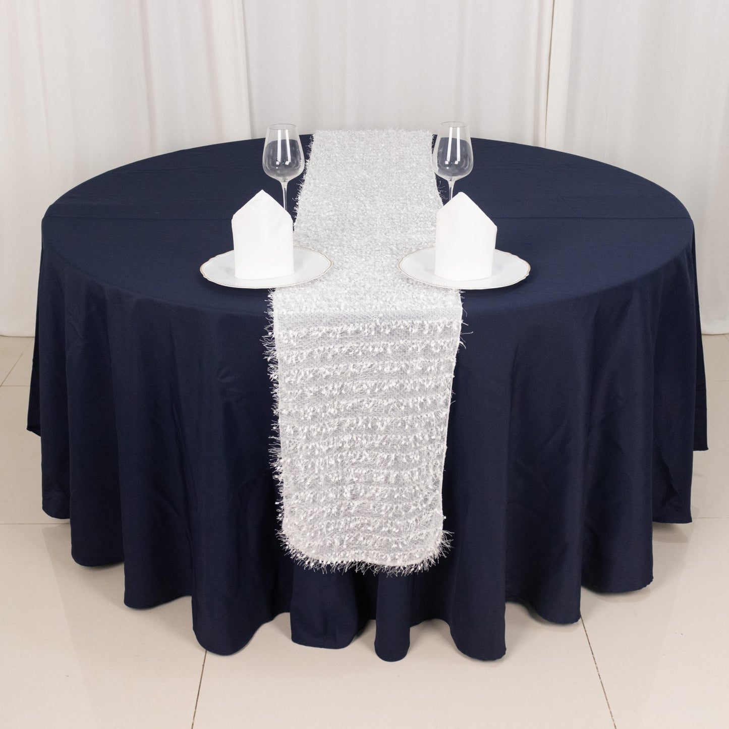 White shag minky polyester table runner on a navy blue table.
