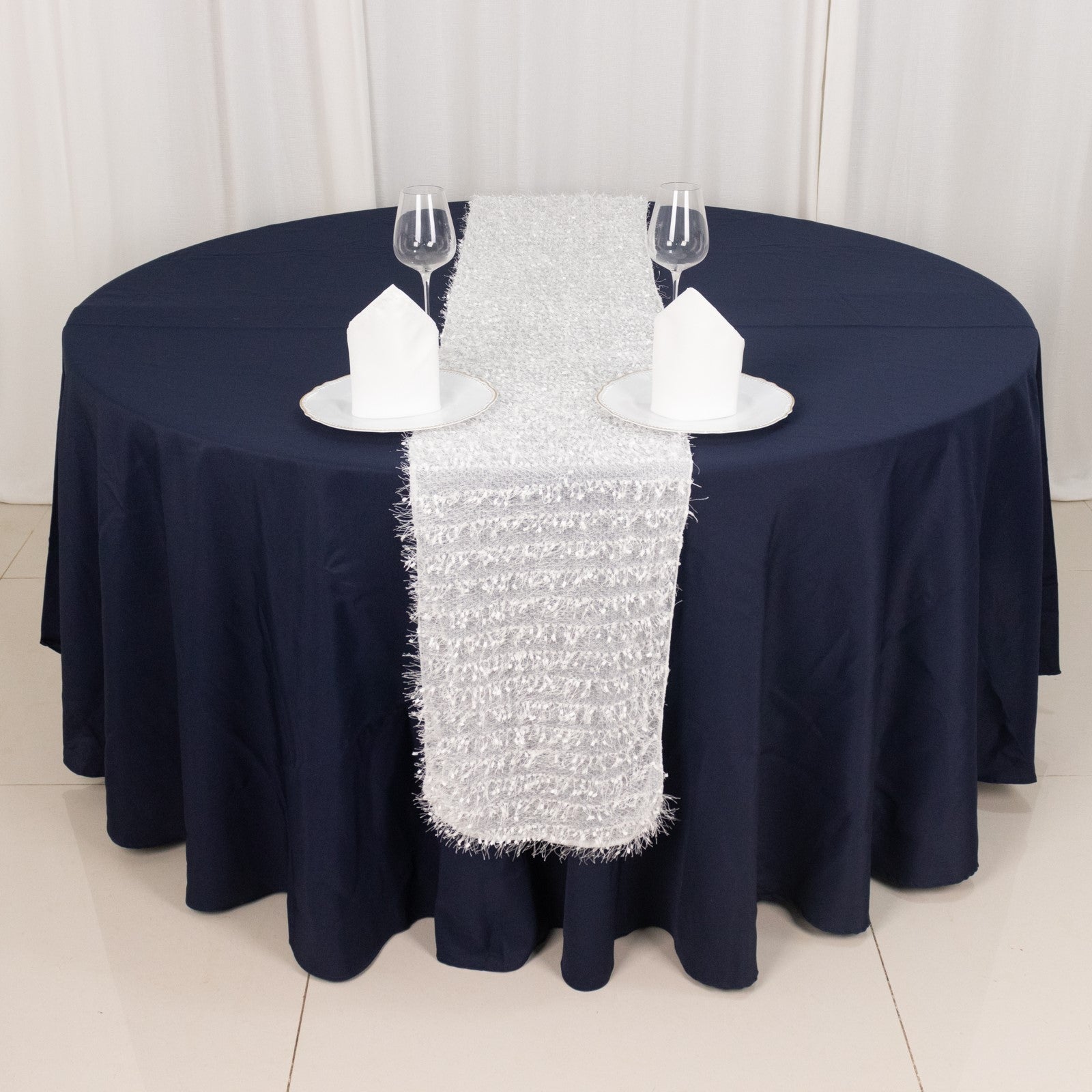 White shag minky polyester table runner on a navy blue table.