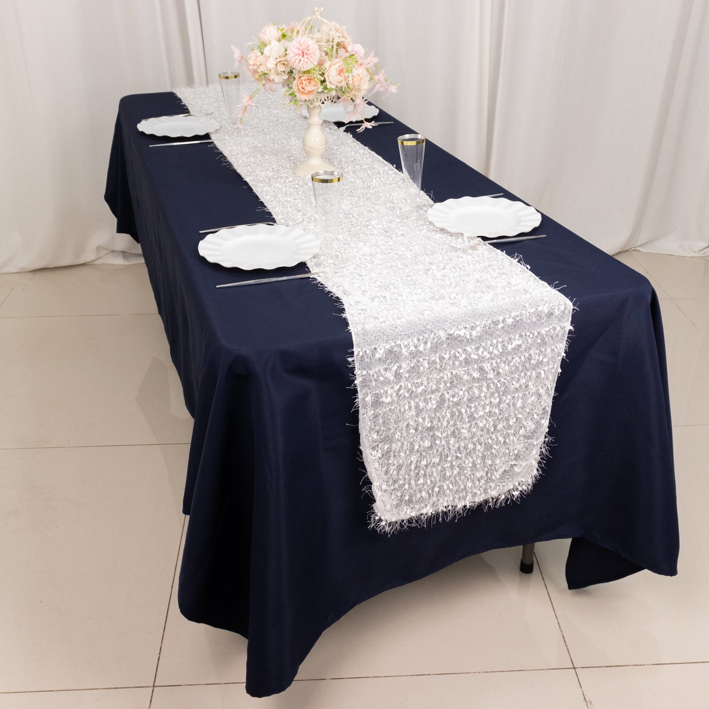 White shag minky polyester table runner on a navy blue tablecloth.