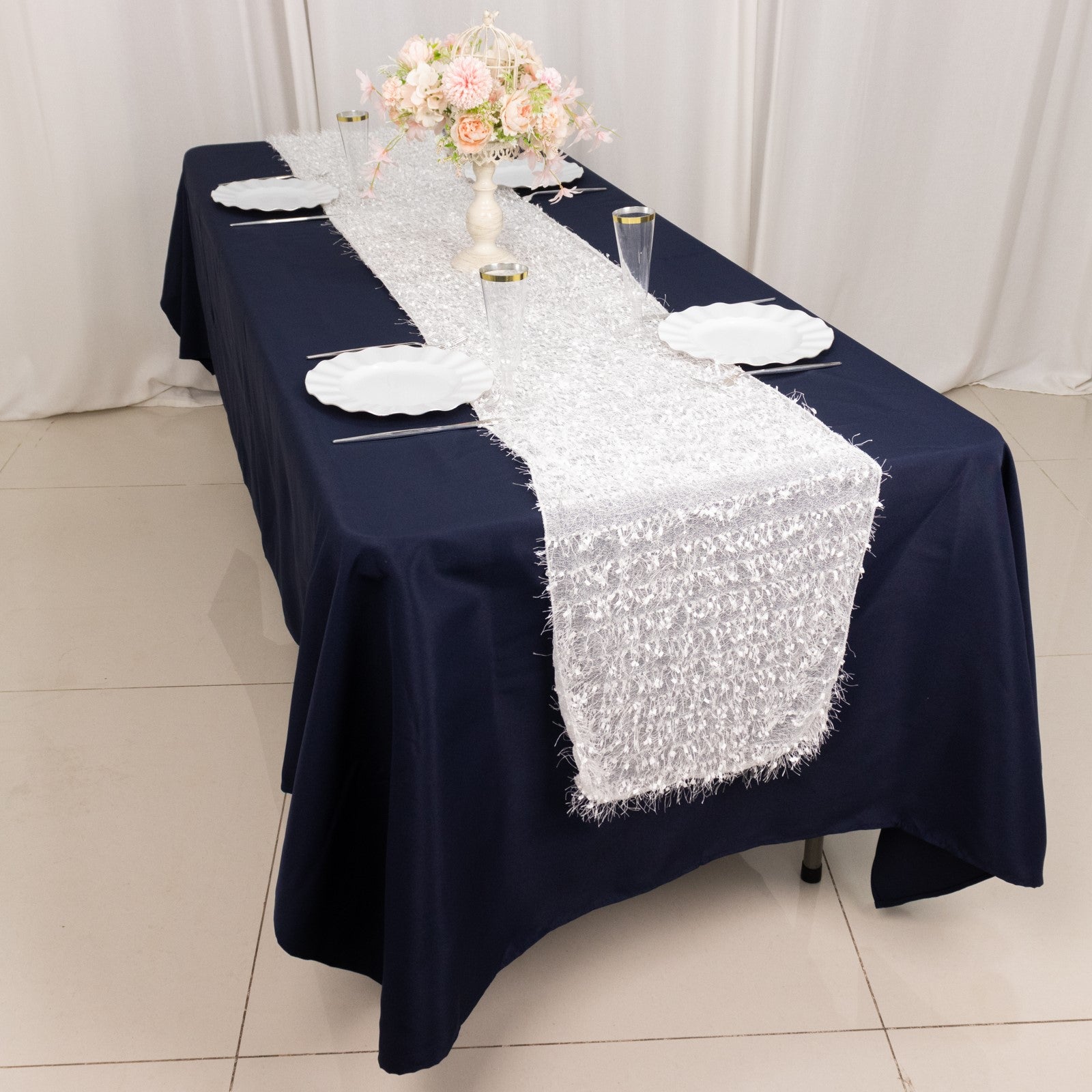 White shag minky polyester table runner on a navy blue tablecloth.