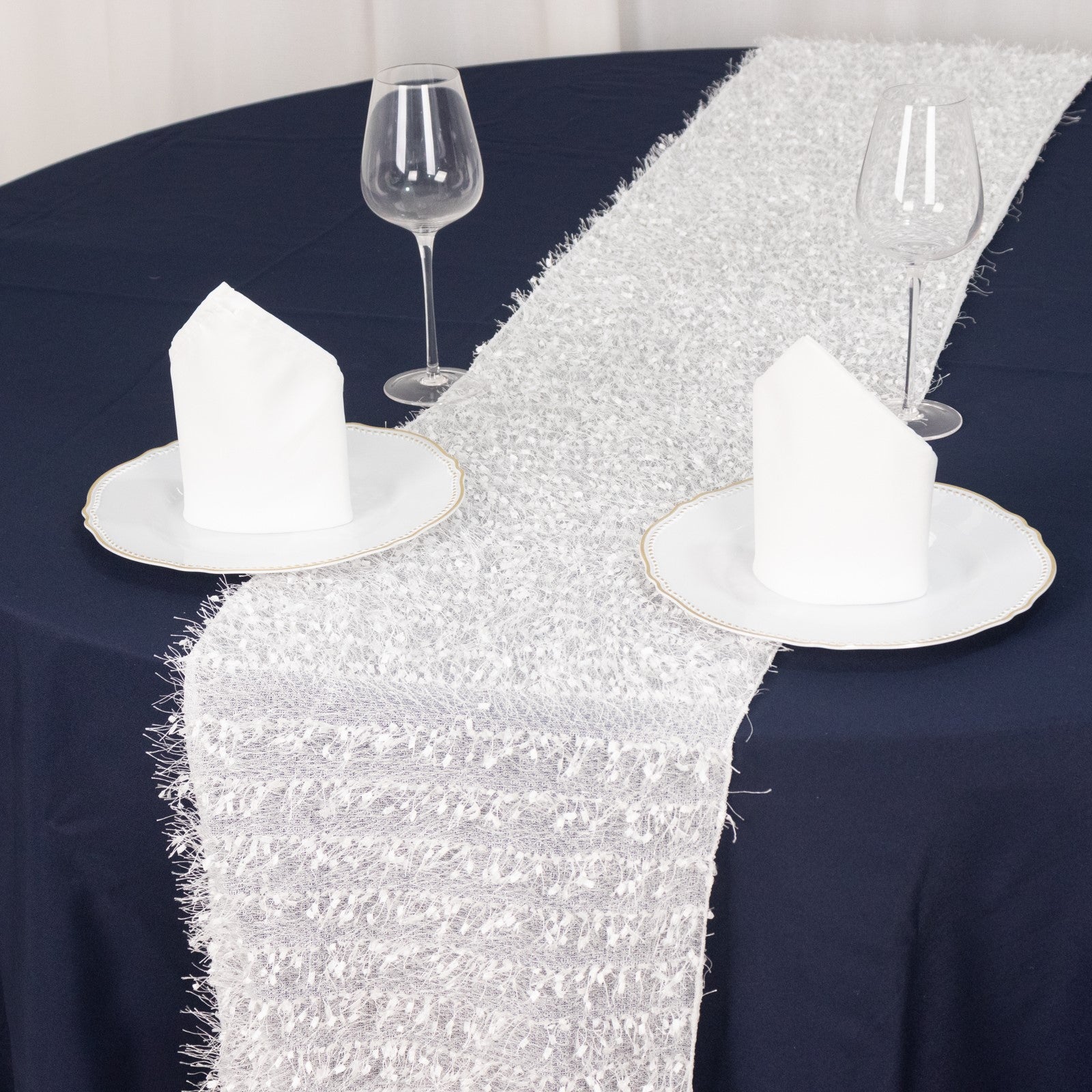 White shag minky polyester table runner on a navy blue table.