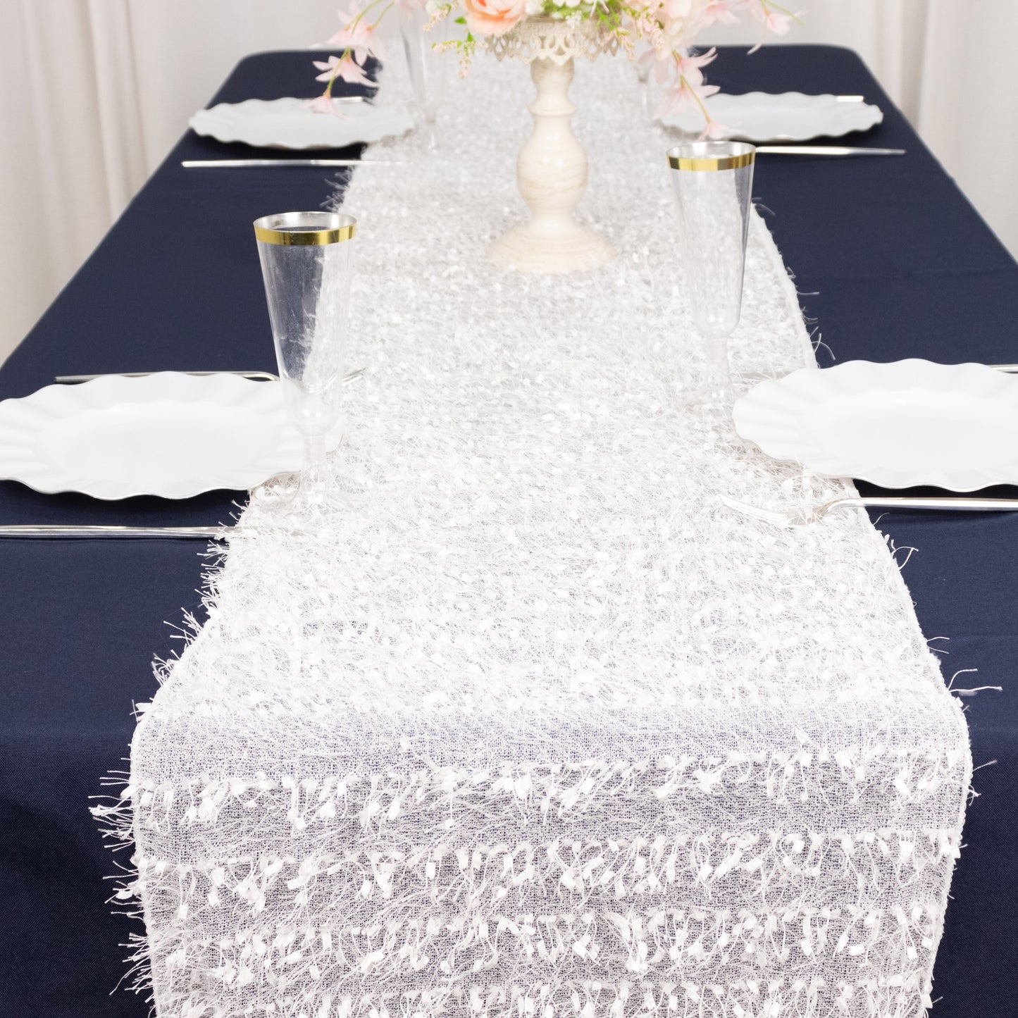 White shag minky polyester table runner on a navy blue table.