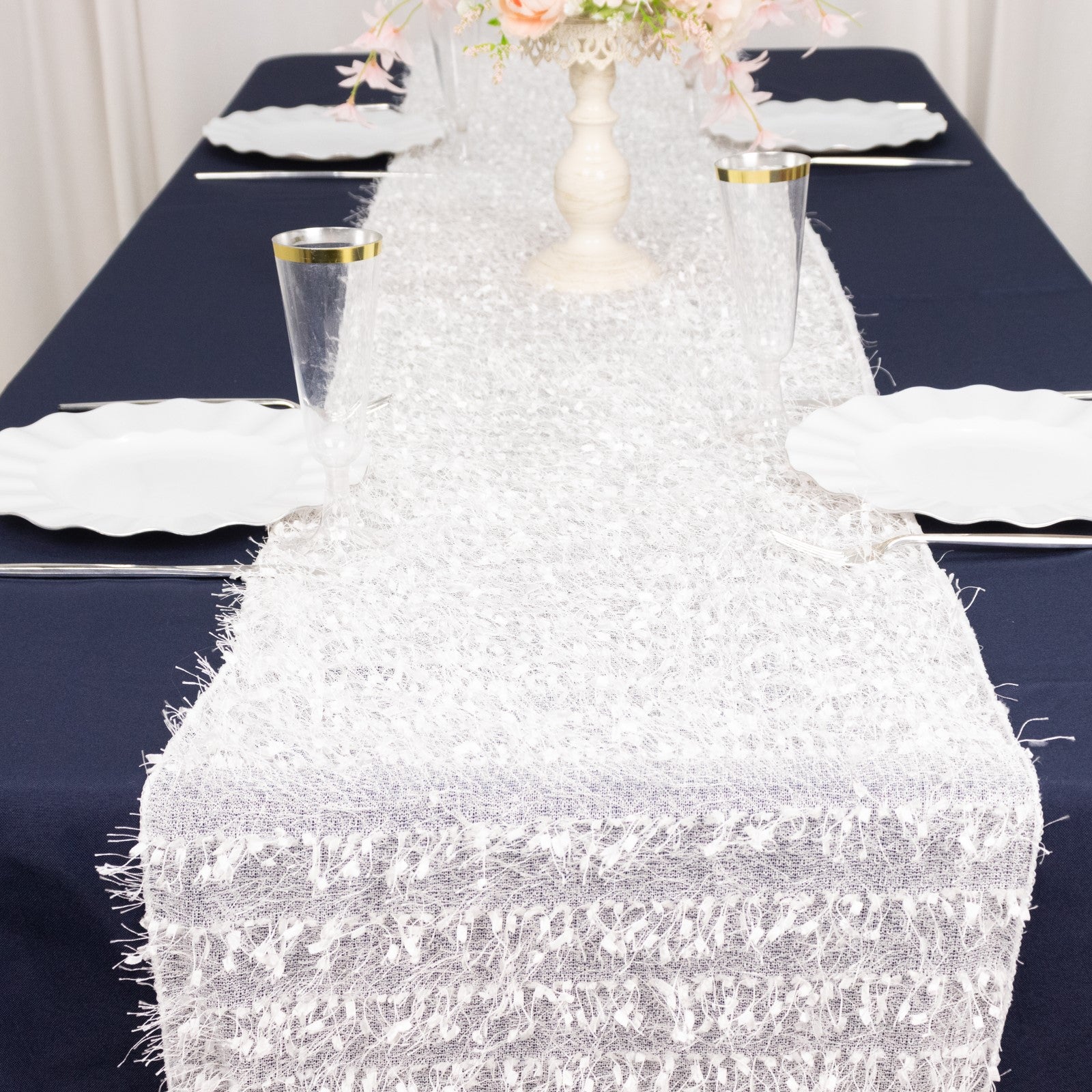 White shag minky polyester table runner on a navy blue table.