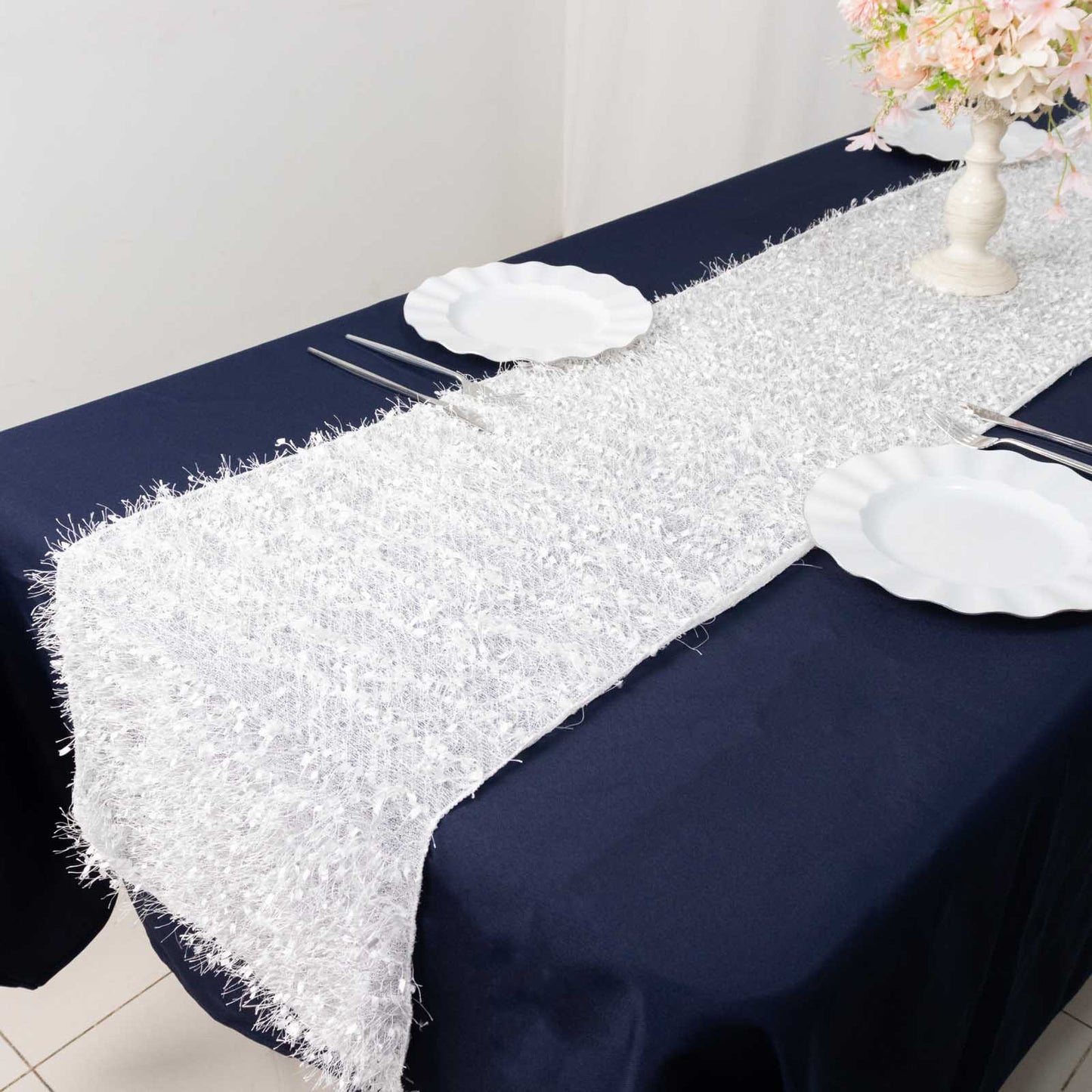 White shag minky polyester table runner on a dark blue table.