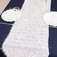 White shag minky polyester table runner on a dark blue table.