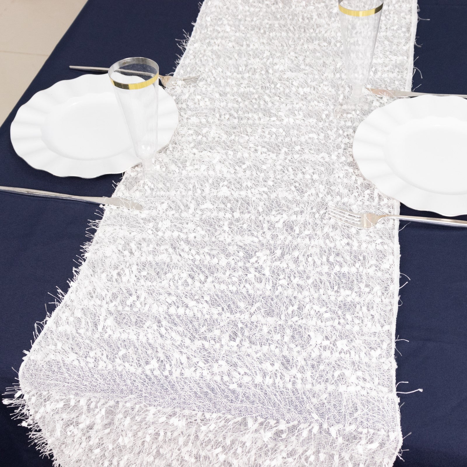 White shag minky polyester table runner on a dark blue table.