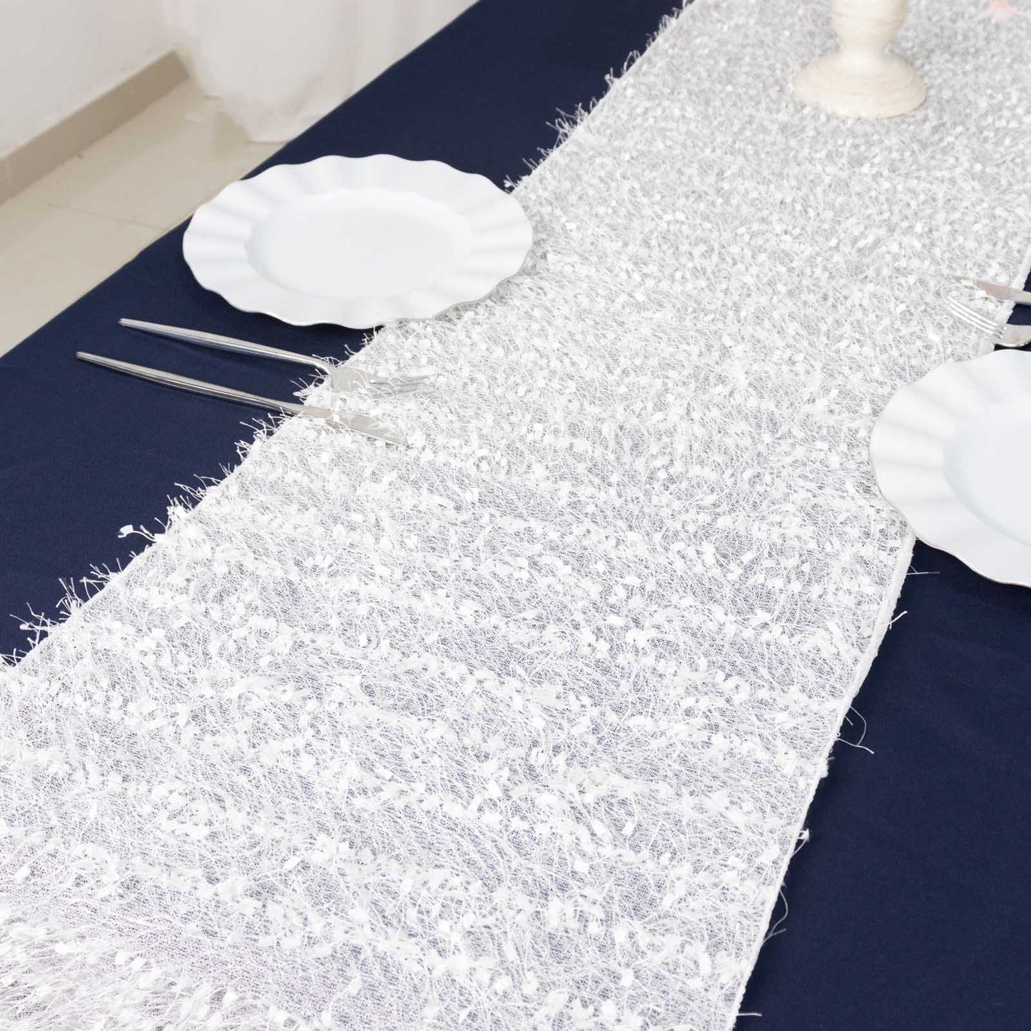 White shag minky polyester table runner on a dark blue table.
