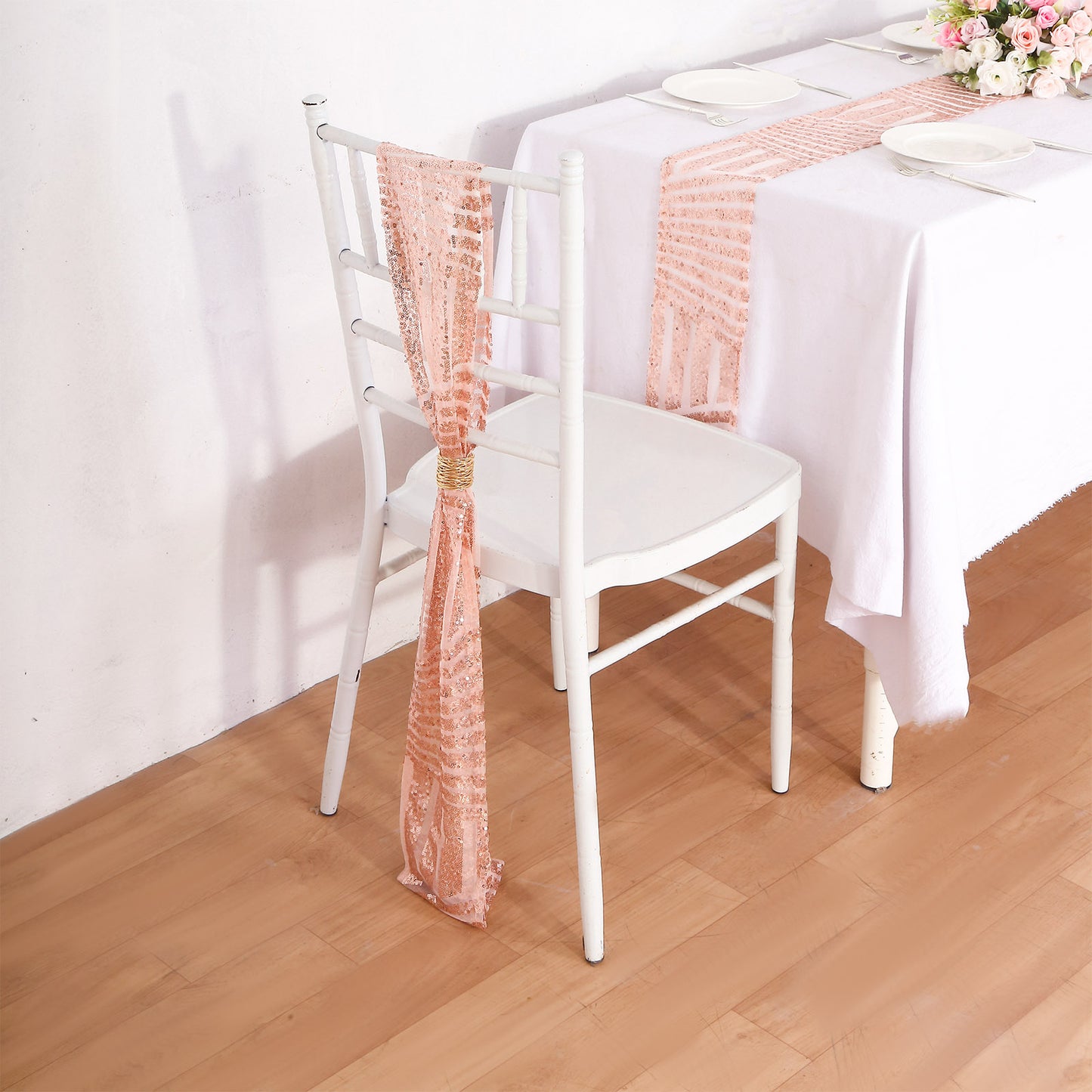 Rose gold geometric diamond glitz sequin chair sash on a white chair.